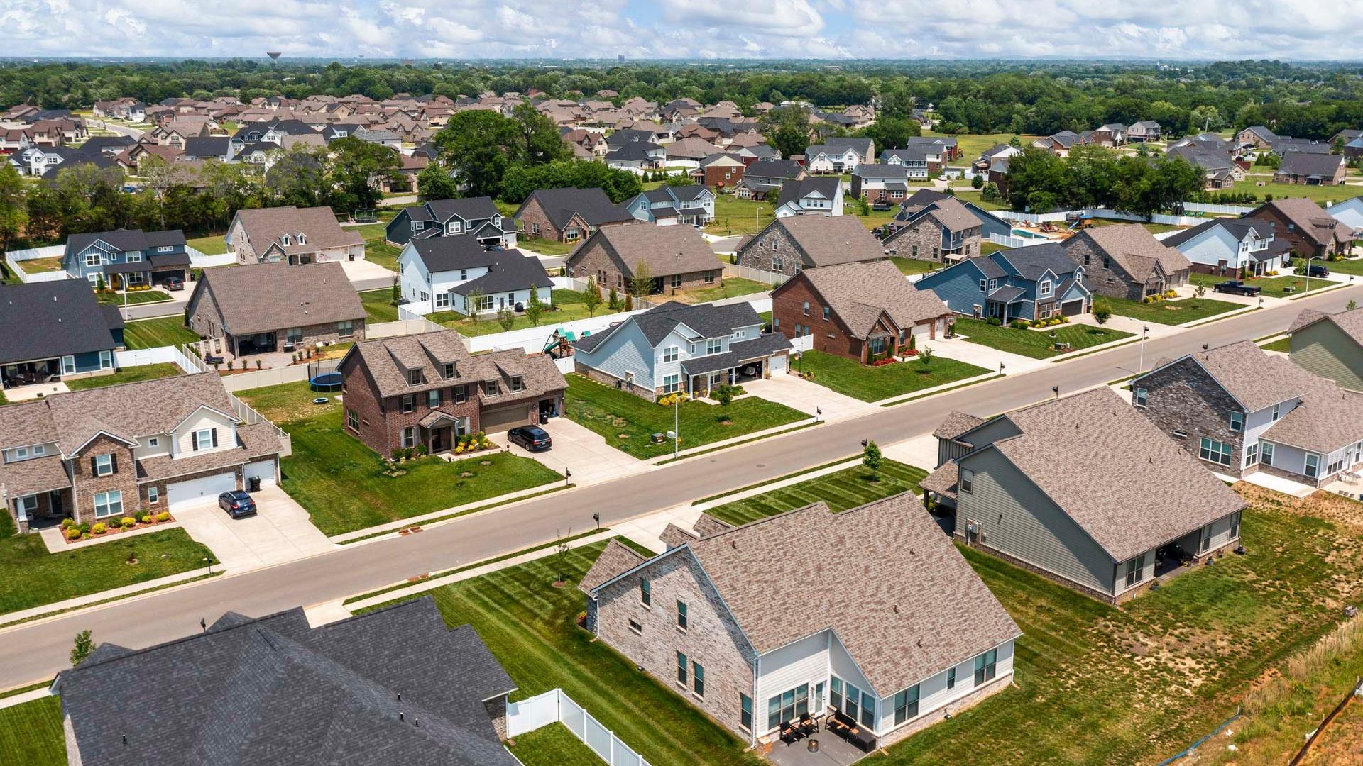 Aerial view of Rivers Edge neighborhood in Murfreesboro TN with modern single-family homes, shingle roofs, driveways, and green lawns