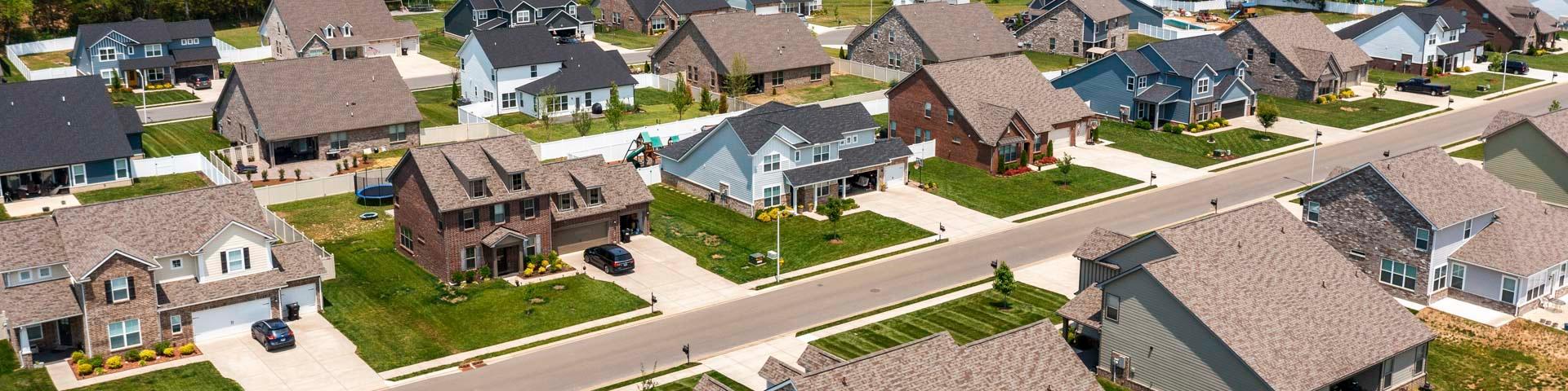 Aerial view of Rivers Edge neighborhood in Murfreesboro TN with modern single-family homes, shingle roofs, driveways, and green lawns