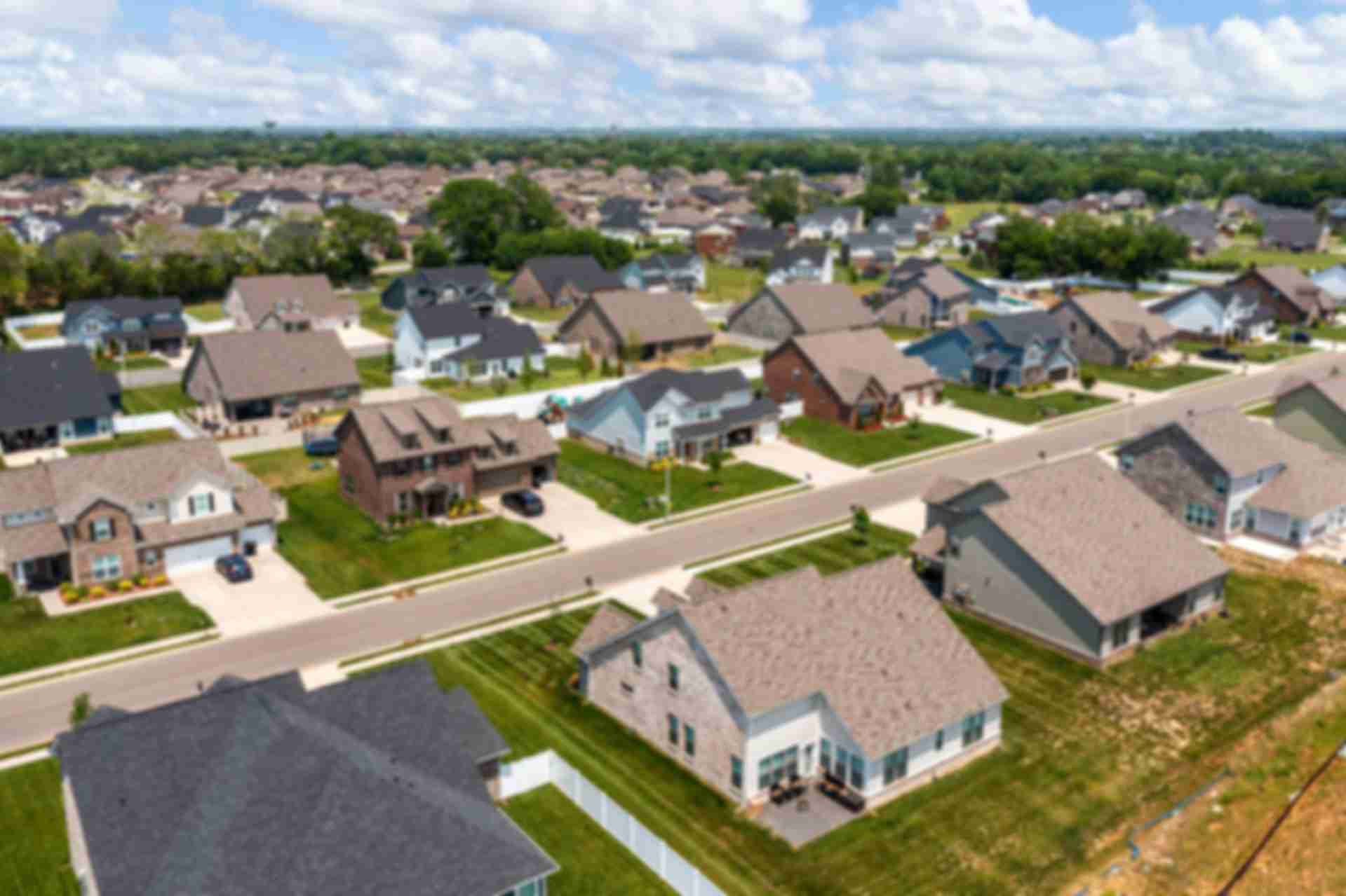 Aerial view of Rivers Edge neighborhood in Murfreesboro TN with modern single-family homes, shingle roofs, driveways, and green lawns
