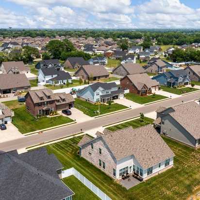Aerial view of Rivers Edge neighborhood in Murfreesboro TN with modern single-family homes, shingle roofs, driveways, and green lawns