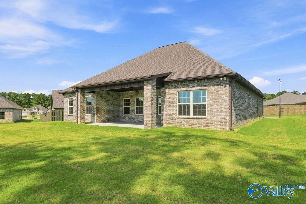 Brick exterior of The Rockford floor plan by Davidson Homes with covered back patio in Cain Park, Hartselle, Alabama.