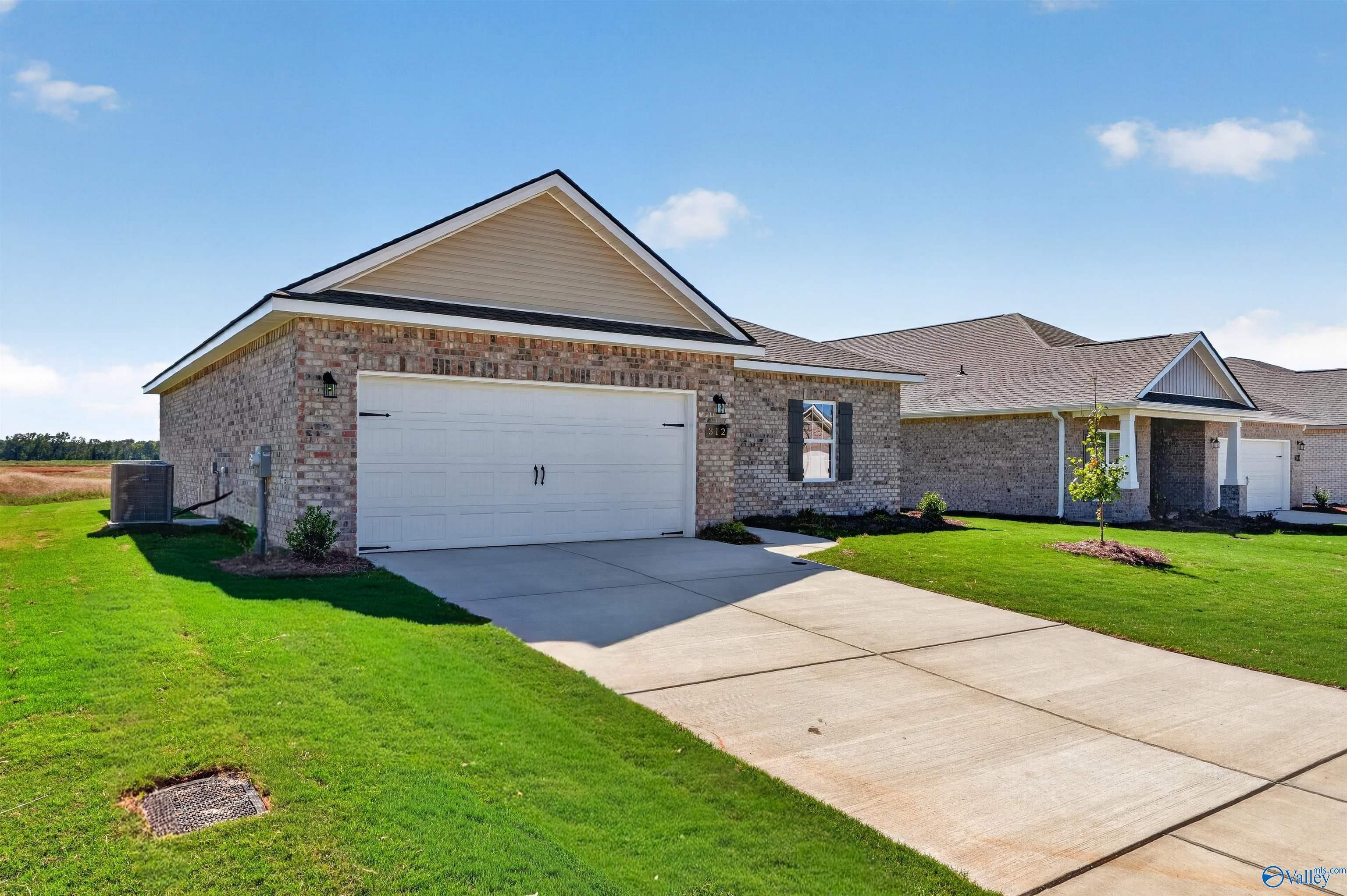 Brick 1-story home with 2-car garage and landscaped lawn in Clearview, Davidson Homes' The Butler plan, Hazel Green, Alabama