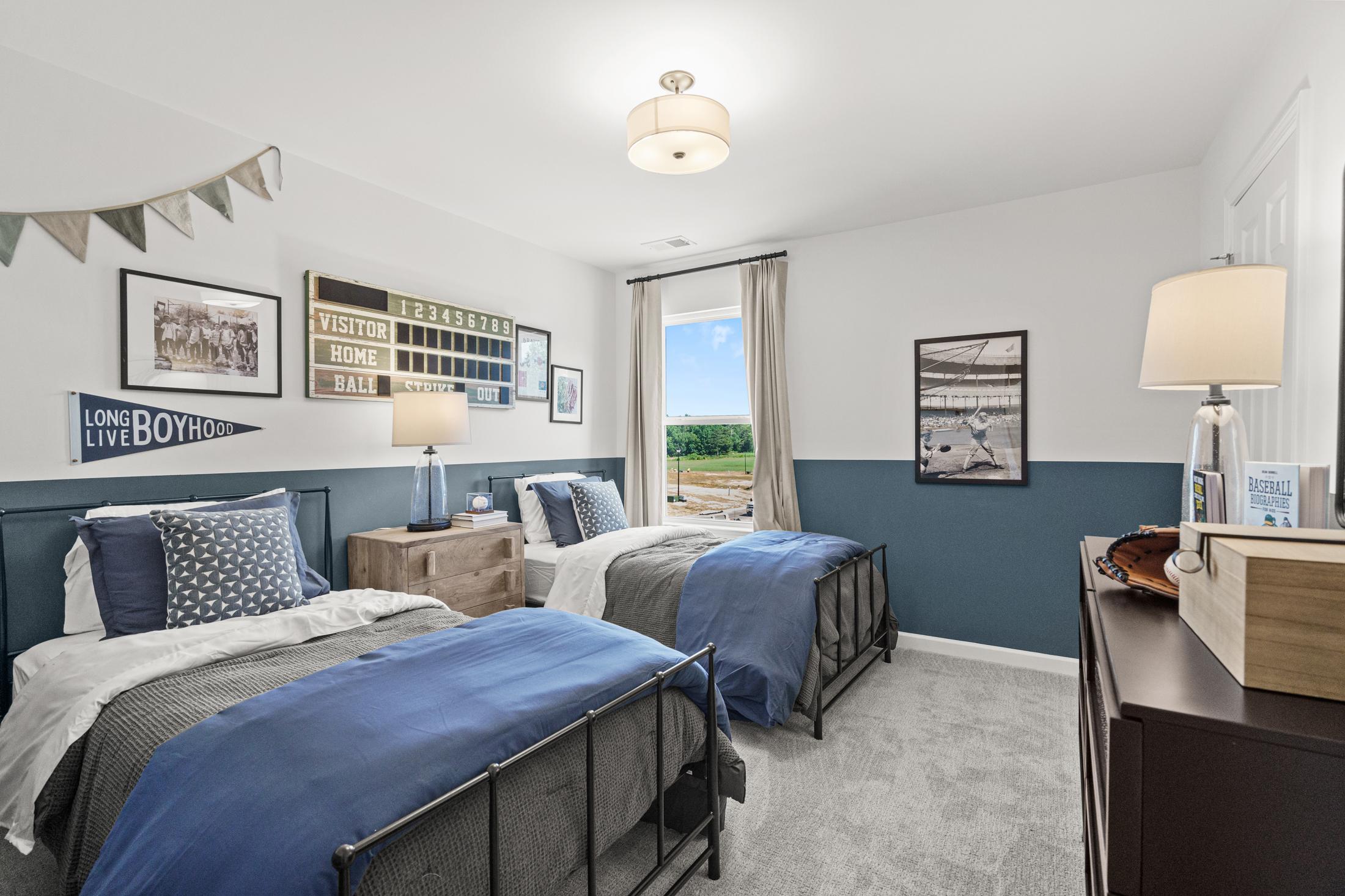Baseball-themed boy's bedroom in The Hickory B at Wehunt Meadows, Hoschton, GA, with twin beds, blue bedding, and meadow view