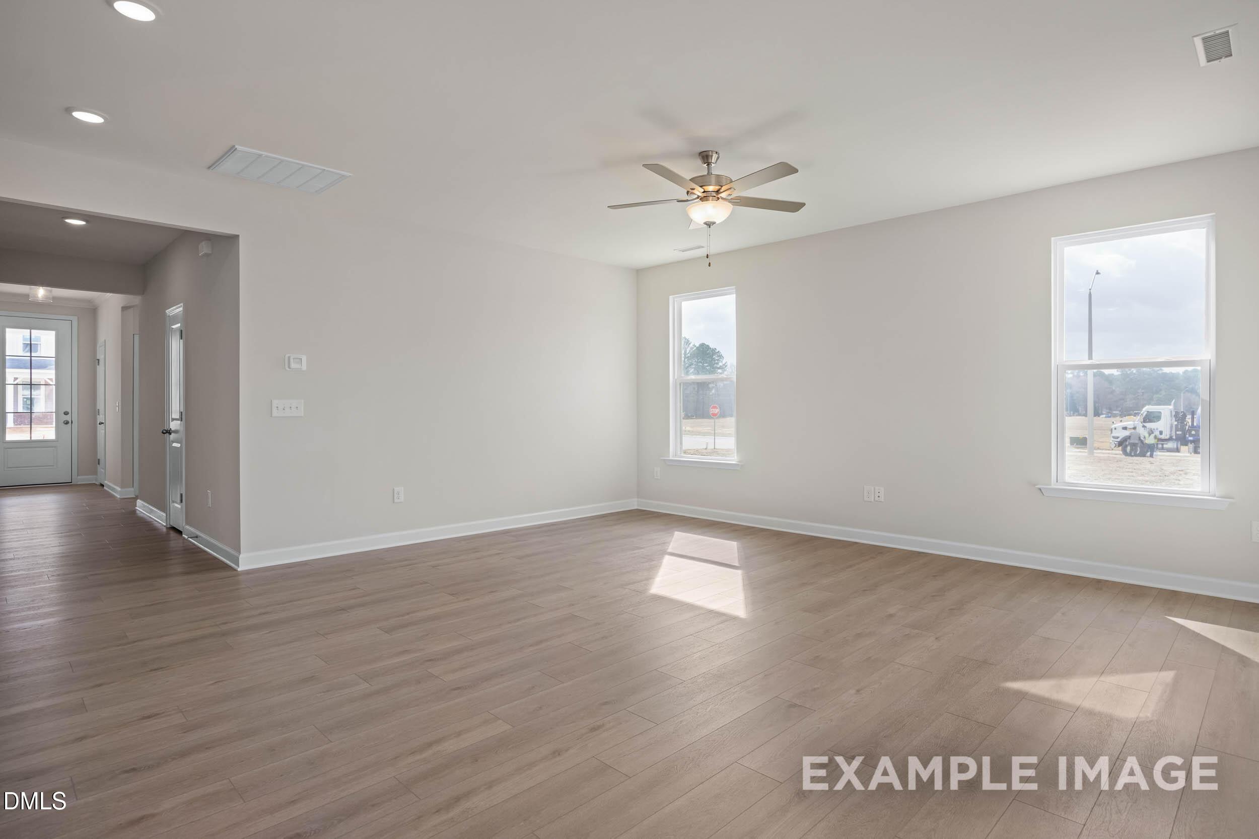 Bright, open-concept living area with wood floors in The Franklin C floor plan at Retreat at North Main in Lillington, NC.