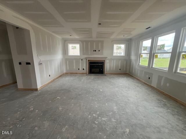 Unfinished living room with fireplace and large windows in The Hickory II C floor plan at Retreat at North Main, Lillington.