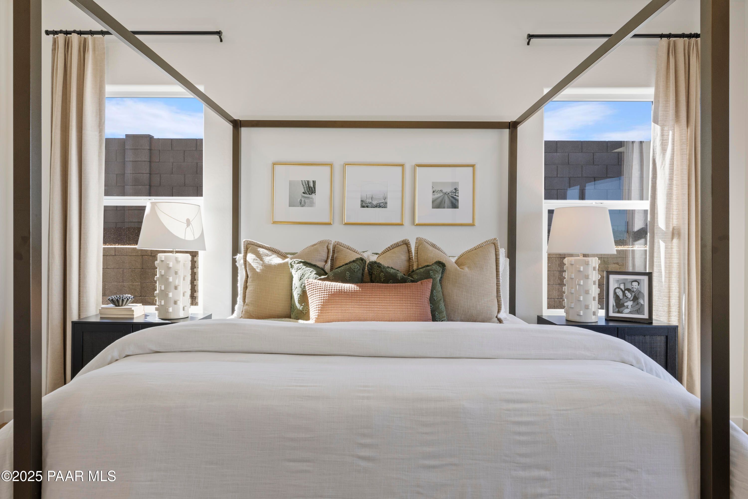 Luxurious master bedroom with king bed, neutral pillows, bedside lamps, and desert-view windows in Davidson Homes The Blaze D, Prescott