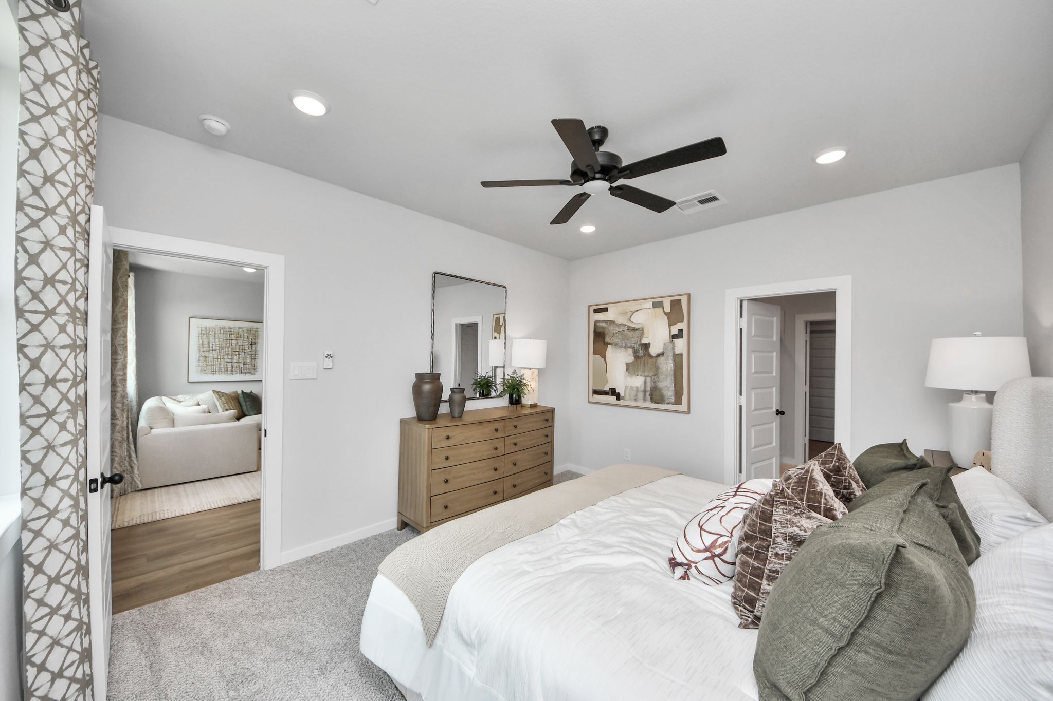 Spacious primary bedroom at Robins Landing in Houston, TX by Davidson Homes with neutral decor and en-suite access.