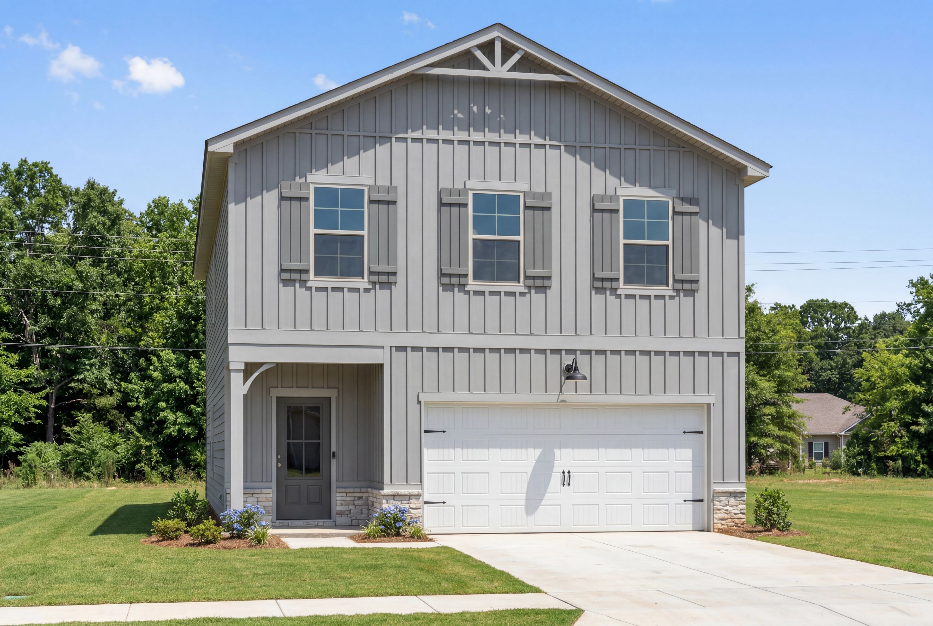 Two-story exterior of The Burton C by Davidson Homes in Cullman, Alabama featuring gray board and batten siding.