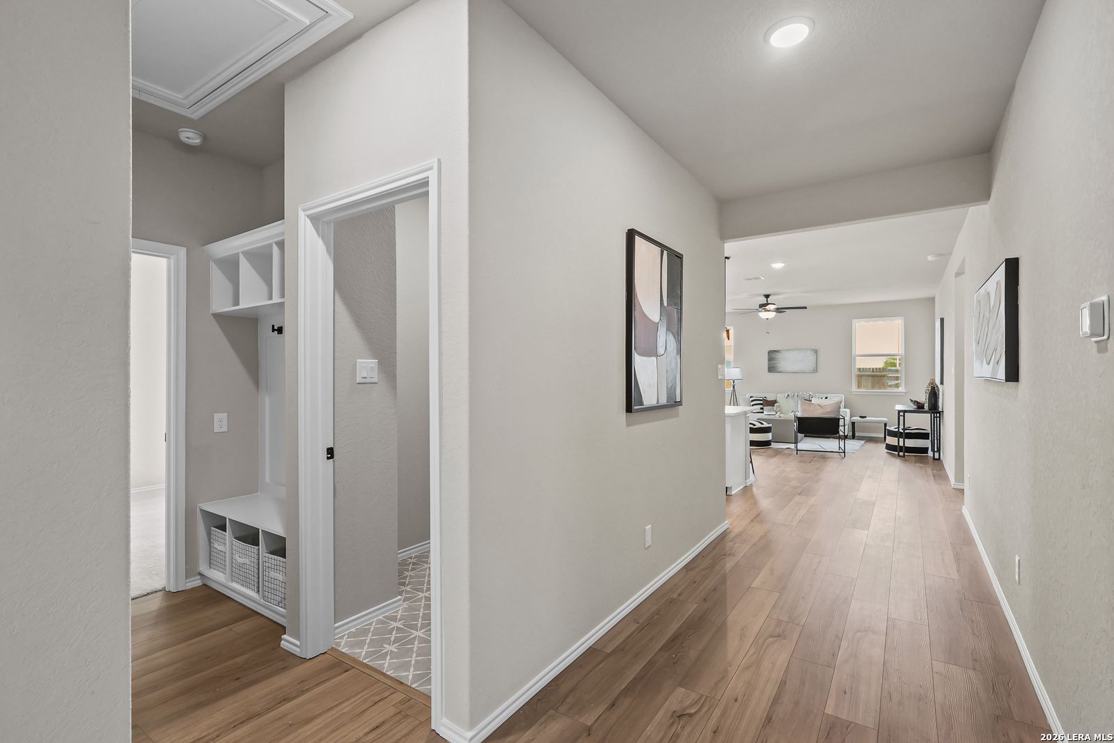 Modern mudroom entry with bench and shelving leading to open-concept living area in Davidson Homes' The Daphne H floor plan.