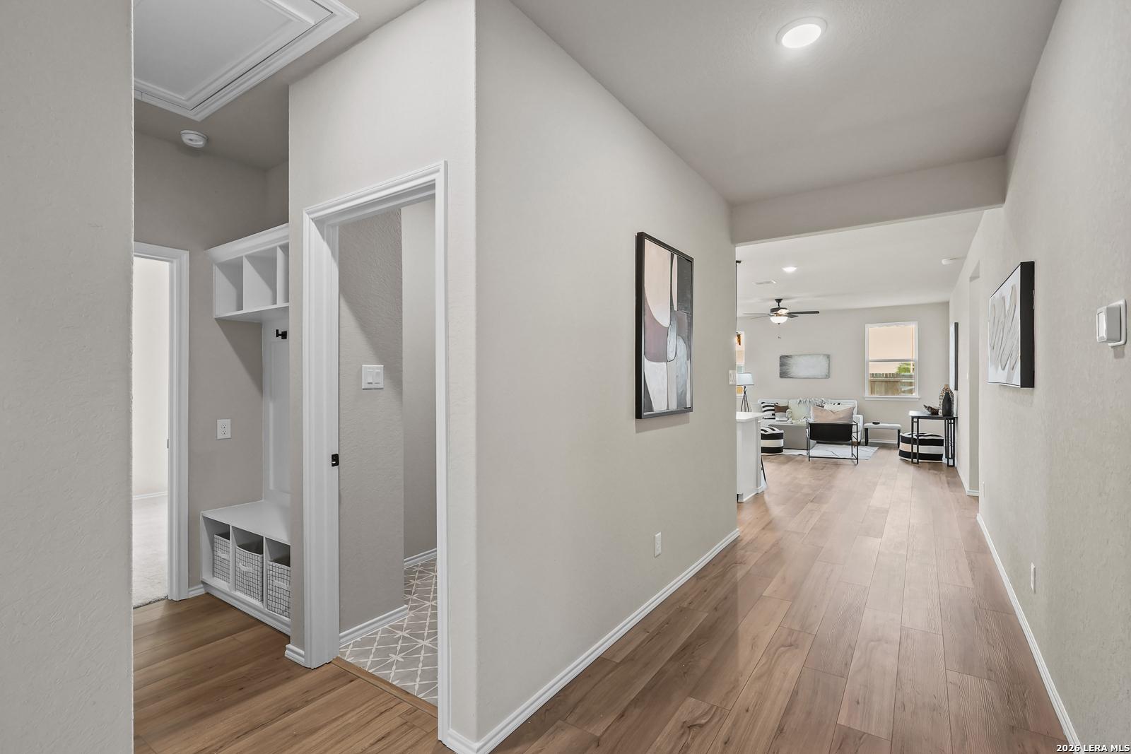 Modern mudroom entry with bench and shelving leading to open-concept living area in Davidson Homes' The Daphne H floor plan.