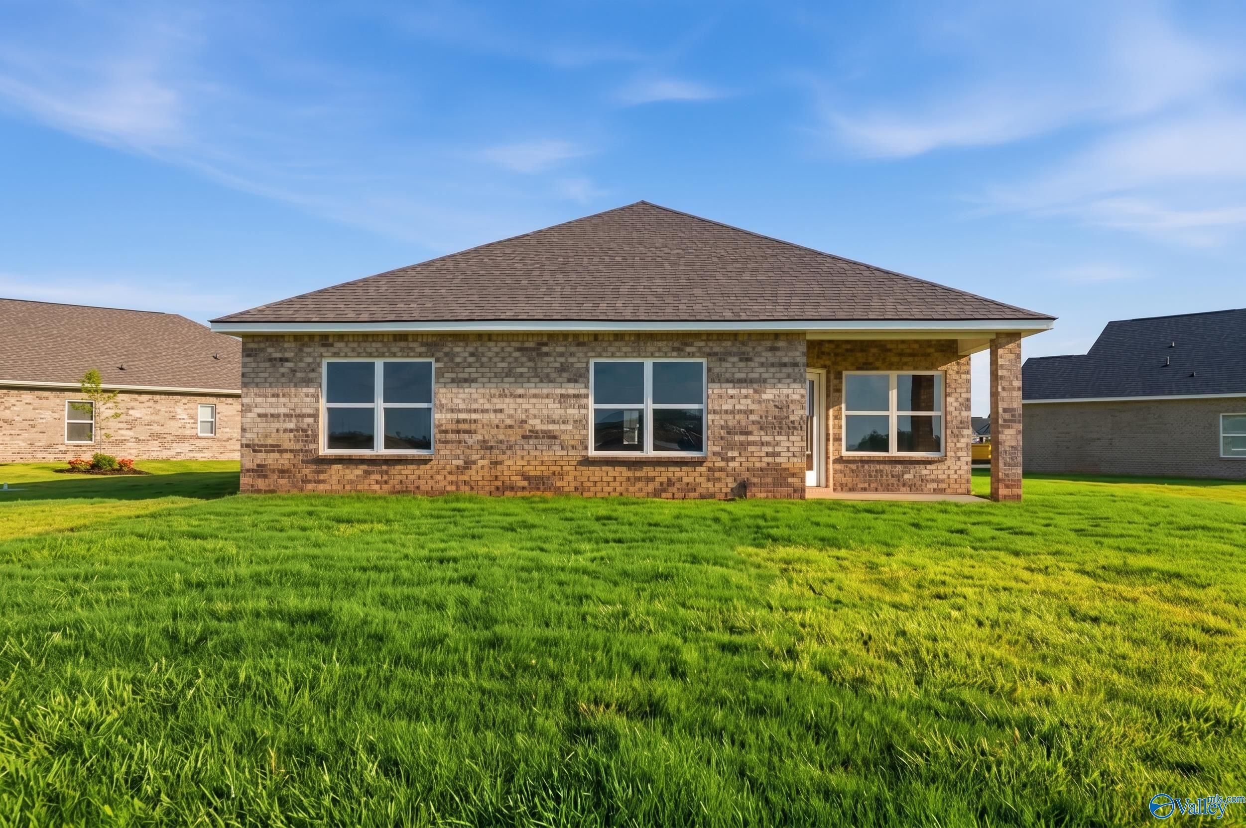 Brick exterior of The Daphne D floor plan by Davidson Homes in Creekside, Harvest, Alabama with spacious backyard.