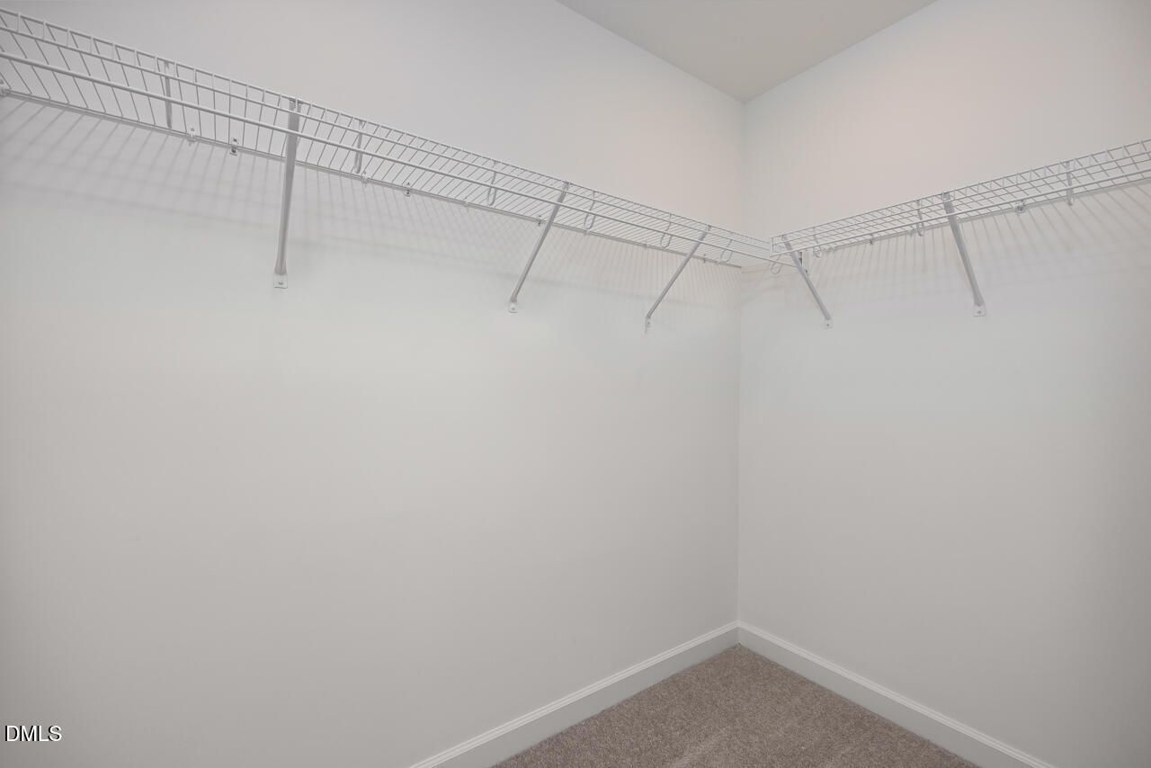 Walk-in closet with white wire shelving in The Mitchell Interior floor plan at Camden Park, Knightdale, North Carolina.