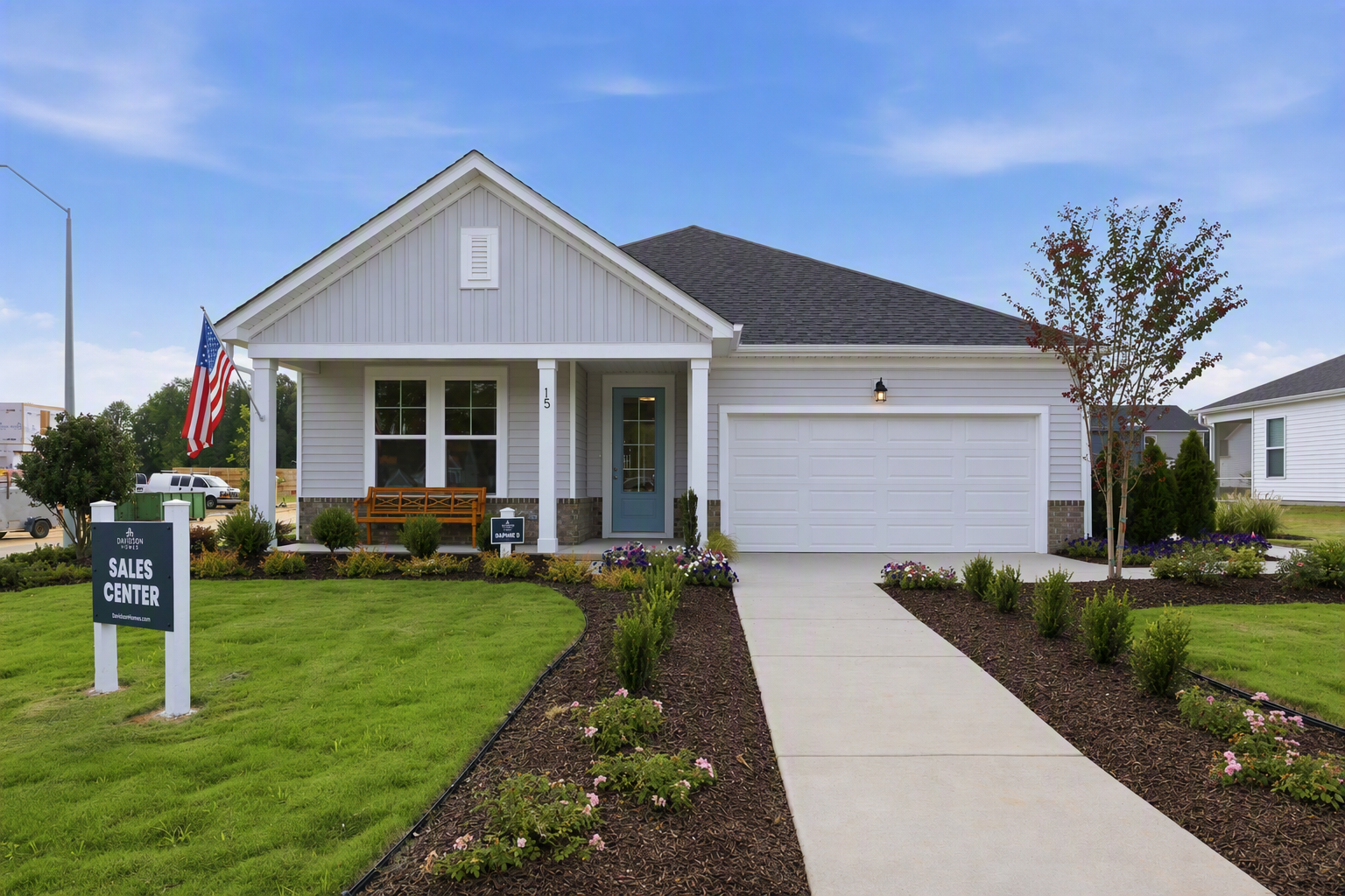 Single-story ranch home with covered front porch and two-car garage at Retreat at North Main sales center in Lillington, NC