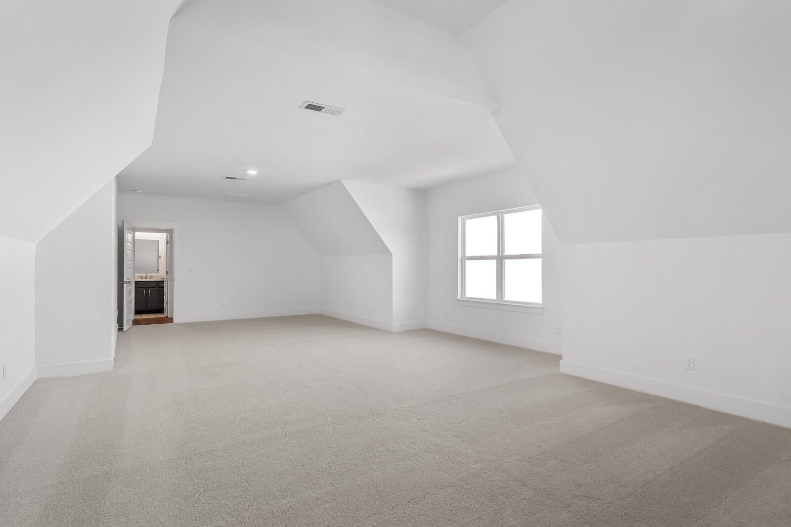 Bright upstairs bedroom with vaulted ceilings, large windows, and en-suite bath access in Davidson Homes The Hawkins, Murfreesboro