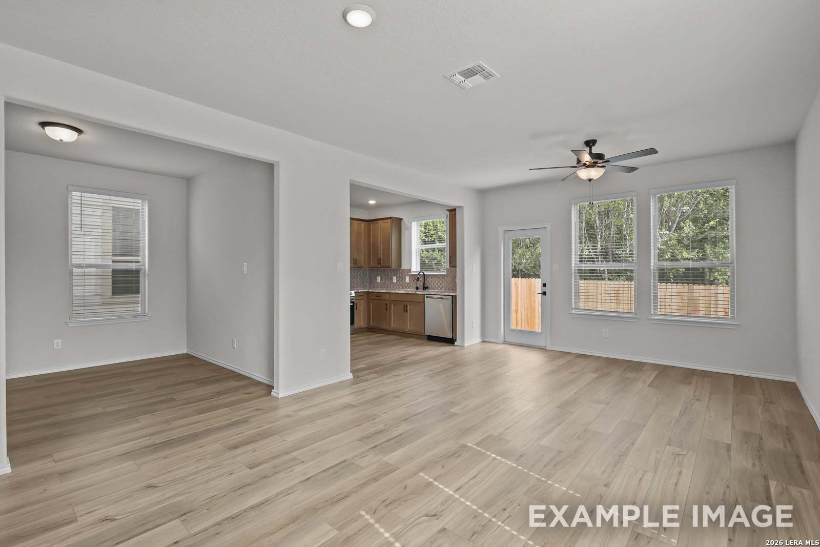 Open-concept living room and kitchen in The Florence A floor plan by Davidson Homes in Cedar Heights, San Antonio, Texas.