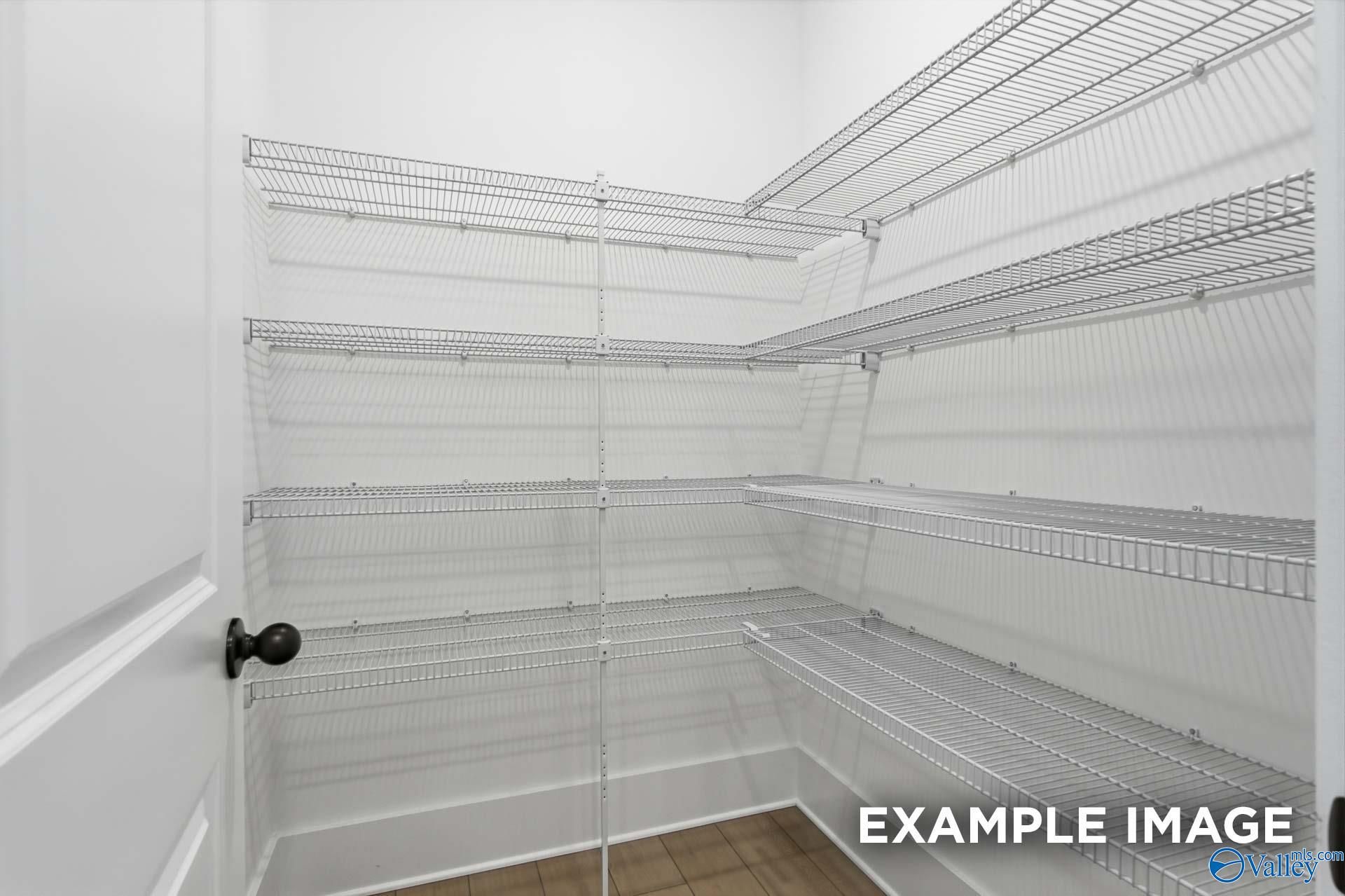 Spacious empty walk-in closet with wire shelving in Davidson Homes The Emory, Hollon Meadow, Decatur, Alabama