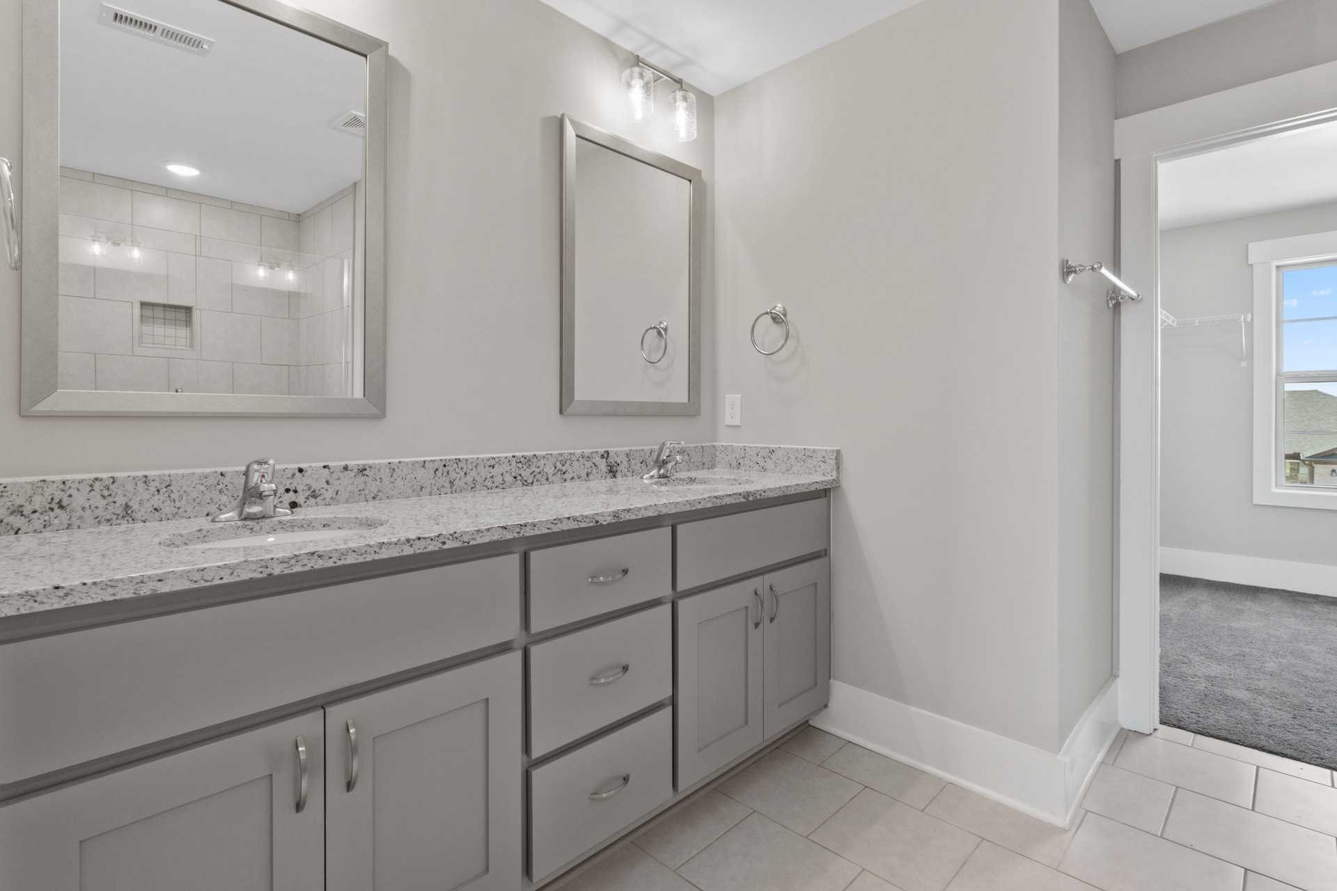 Spacious master bathroom with double vanity, gray shaker cabinets, quartz counters at Little Burwell Estates in Harvest Alabama