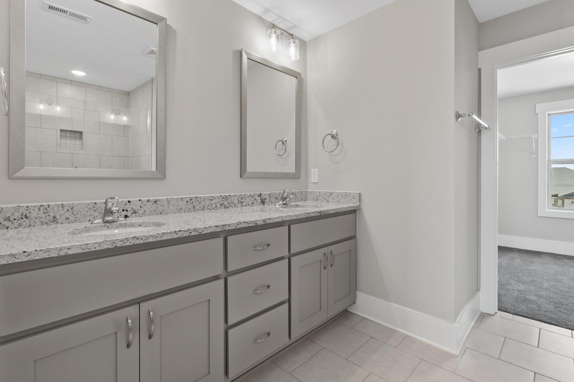 Spacious master bathroom with double vanity, gray shaker cabinets, quartz counters at Little Burwell Estates in Harvest Alabama