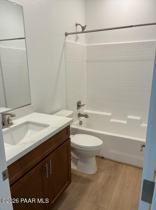 Modern bathroom with white subway tile shower, wood vanity, and quartz countertop in The Coronado A, Prescott, Arizona.