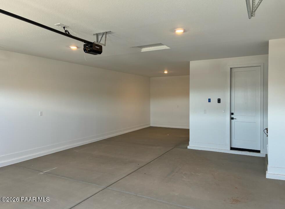 Spacious 3-car garage interior with concrete flooring in The Durango II G floor plan, South Ranch, Prescott, Arizona.