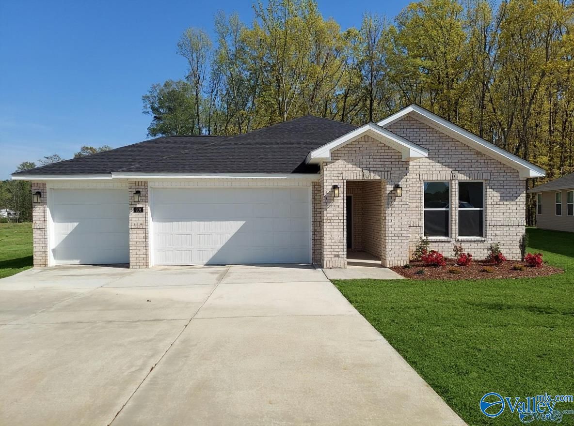 Modern 1-story 4-bedroom brick home with 2-car garage, black roof, and landscaped yard in Forest Glen, Hazel Green, AL by Davidson Homes The Luna