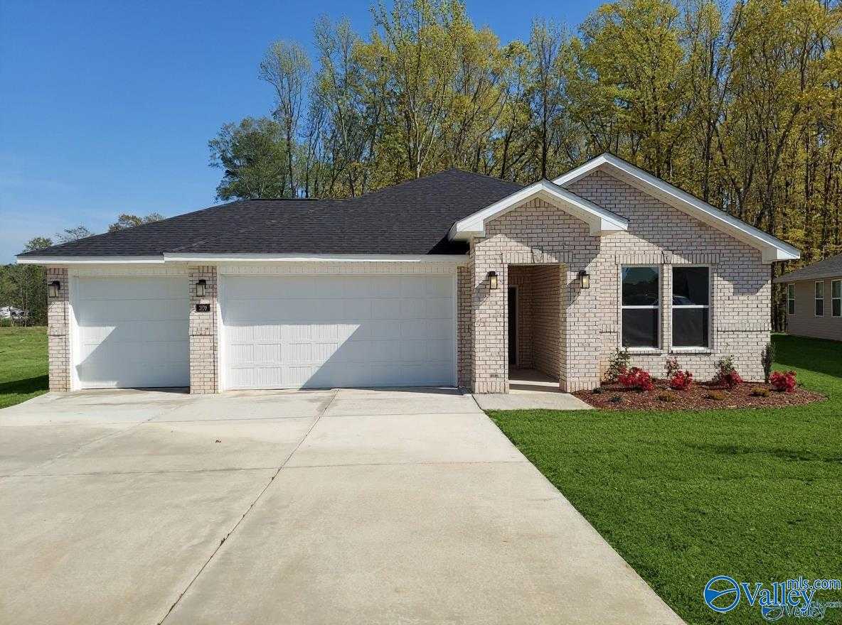 Modern 1-story 4-bedroom brick home with 2-car garage, black roof, and landscaped yard in Forest Glen, Hazel Green, AL by Davidson Homes The Luna