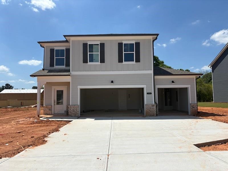 Modern 4-bedroom two-story gray home with 3-car garage and front porch in Cedar Farms, Winder, Georgia - Davidson Homes The Rabun A