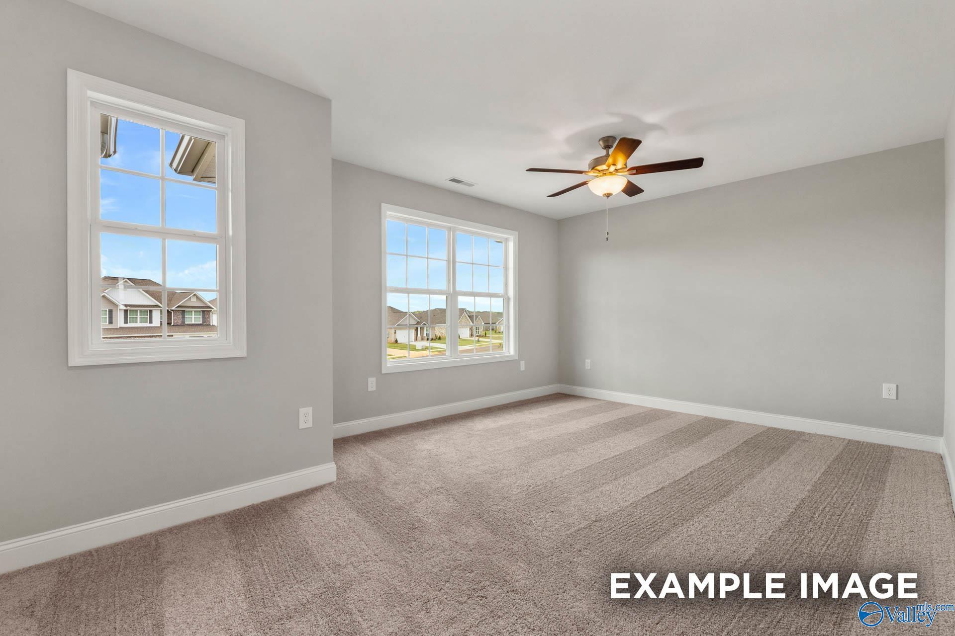 Bright secondary bedroom with gray walls, large windows, ceiling fan, and striped carpet in Davidson Homes The Shelby B, New Market, Alabama