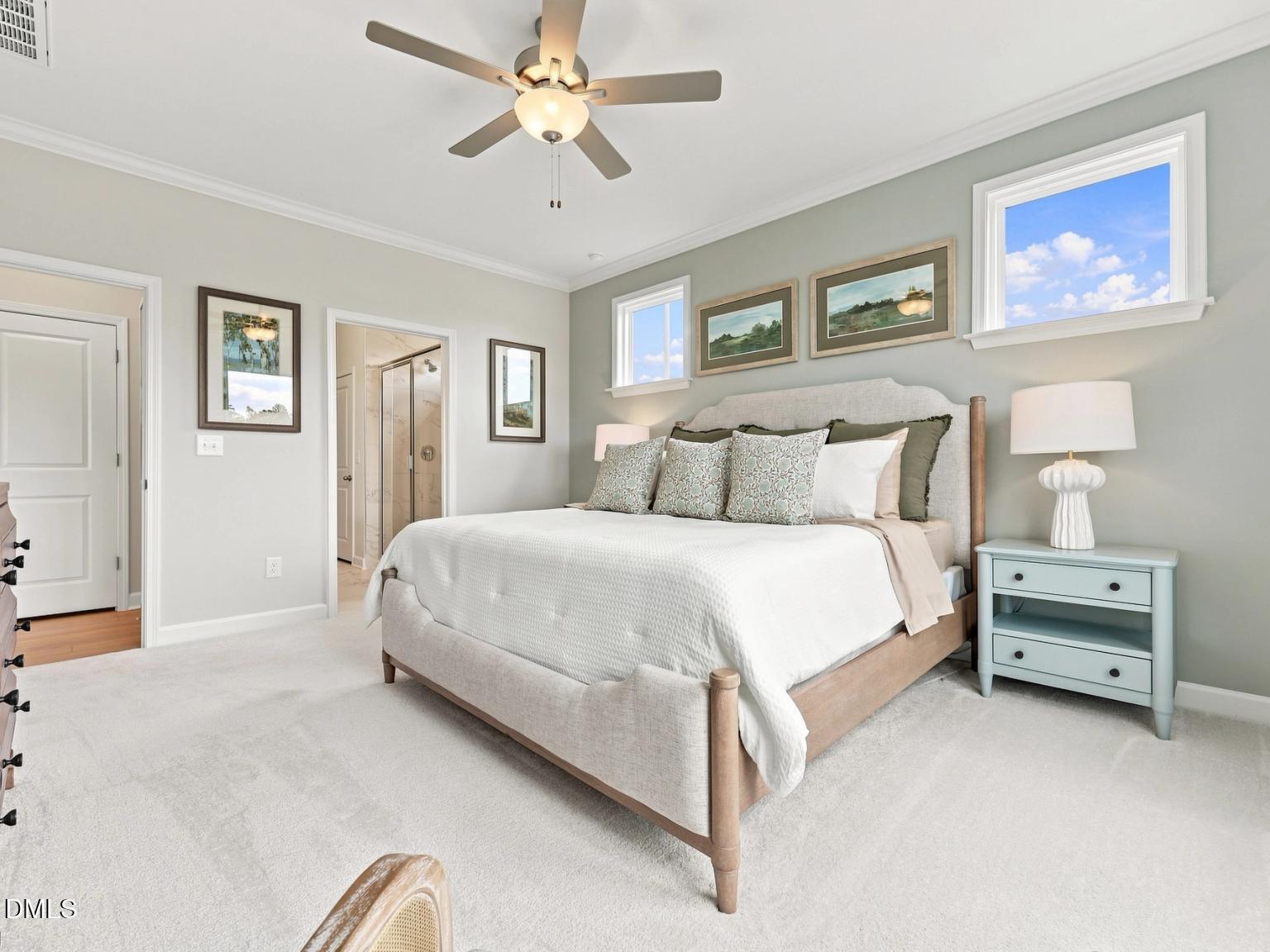 Bright primary bedroom with ceiling fan and ensuite bathroom in The Daphne C floor plan at Woodland Crossing, Zebulon, NC.
