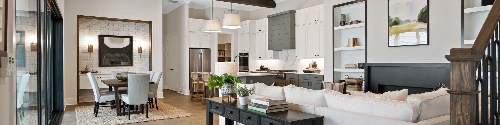 Open-concept kitchen and living area at Manor Estates in Marietta GA with exposed wood beams, hardwood floors, and modern dining setup