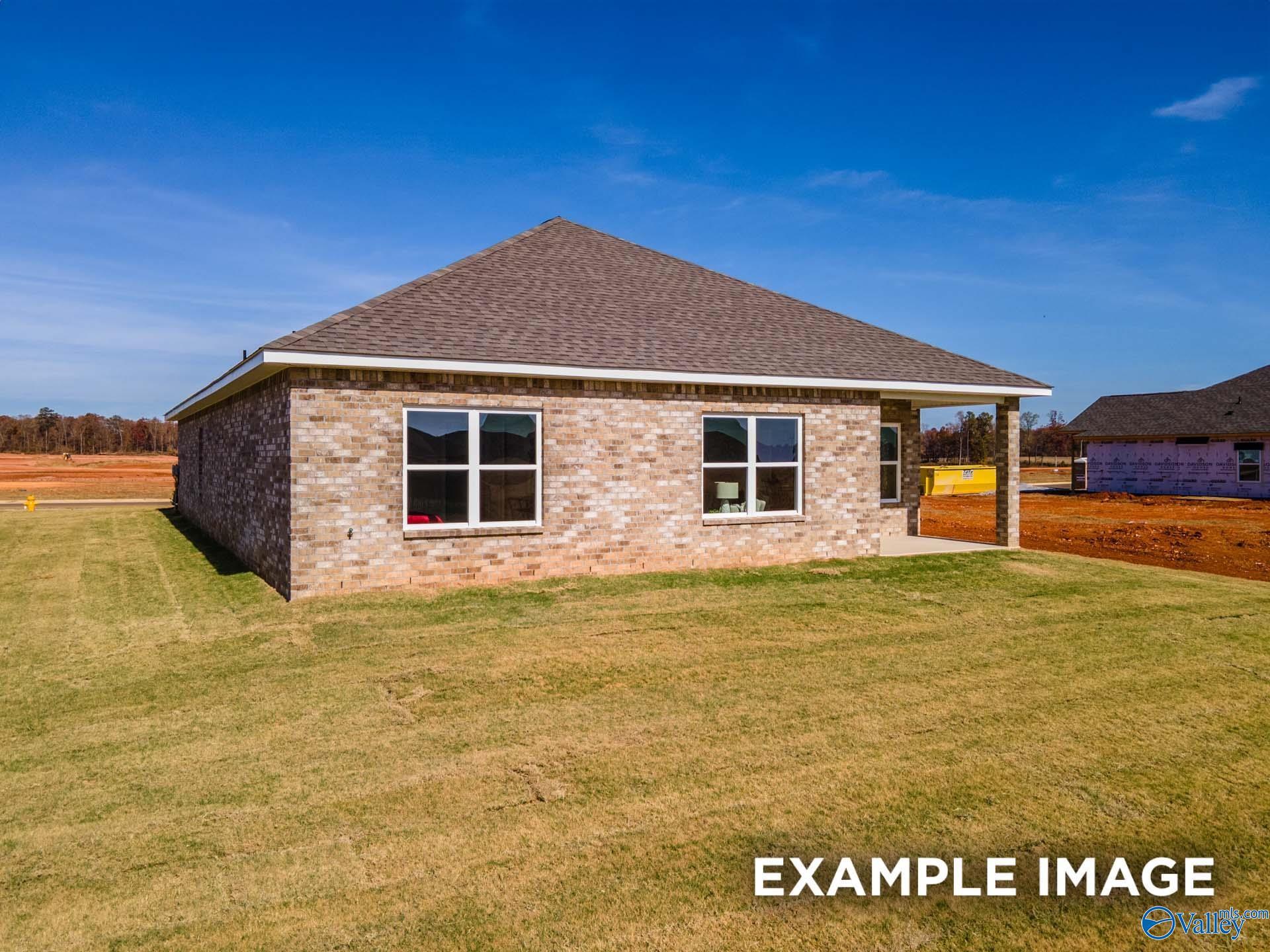 Single-story brick Daphne D home with gabled roof, large windows, and 2-car garage in Walker's Hill, Meridianville, Alabama