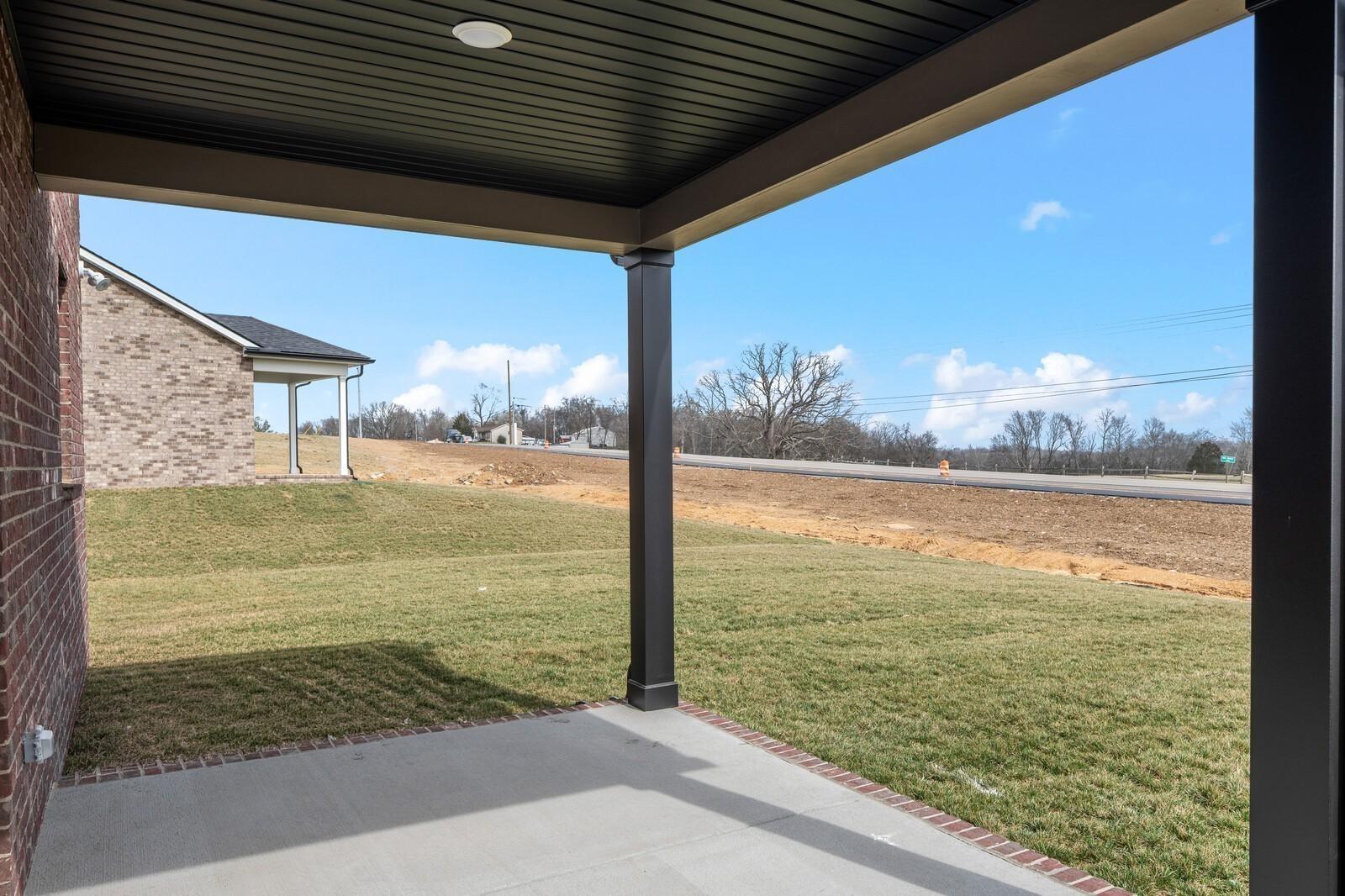 Covered patio view of backyard and landscape in Benders Cove, Mt. Juliet, Tennessee by Davidson Homes.