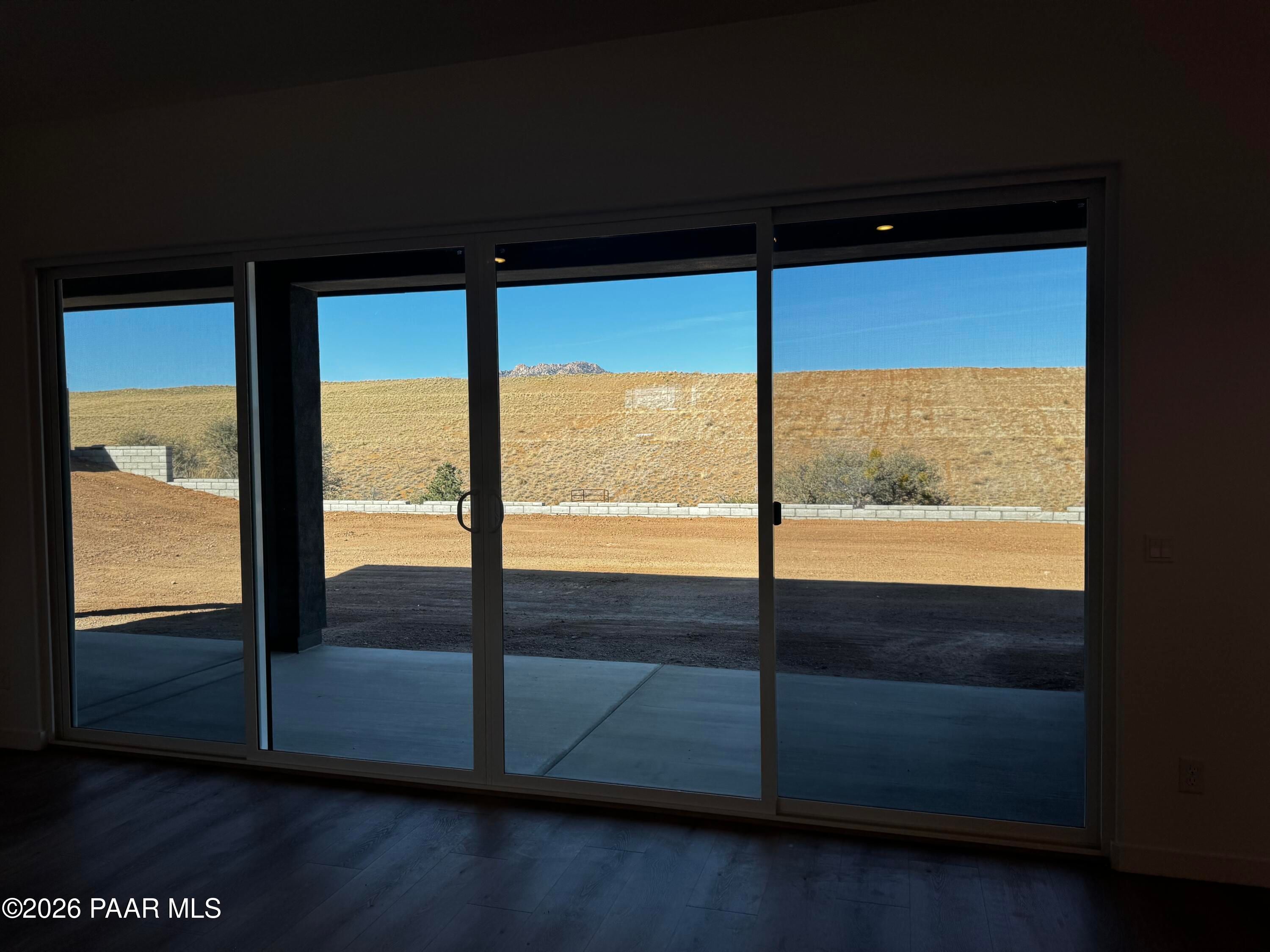 Expansive desert mountain view through triple sliding glass doors in Davidson Homes The Blaze C, Hidden Hills, Prescott, Arizona