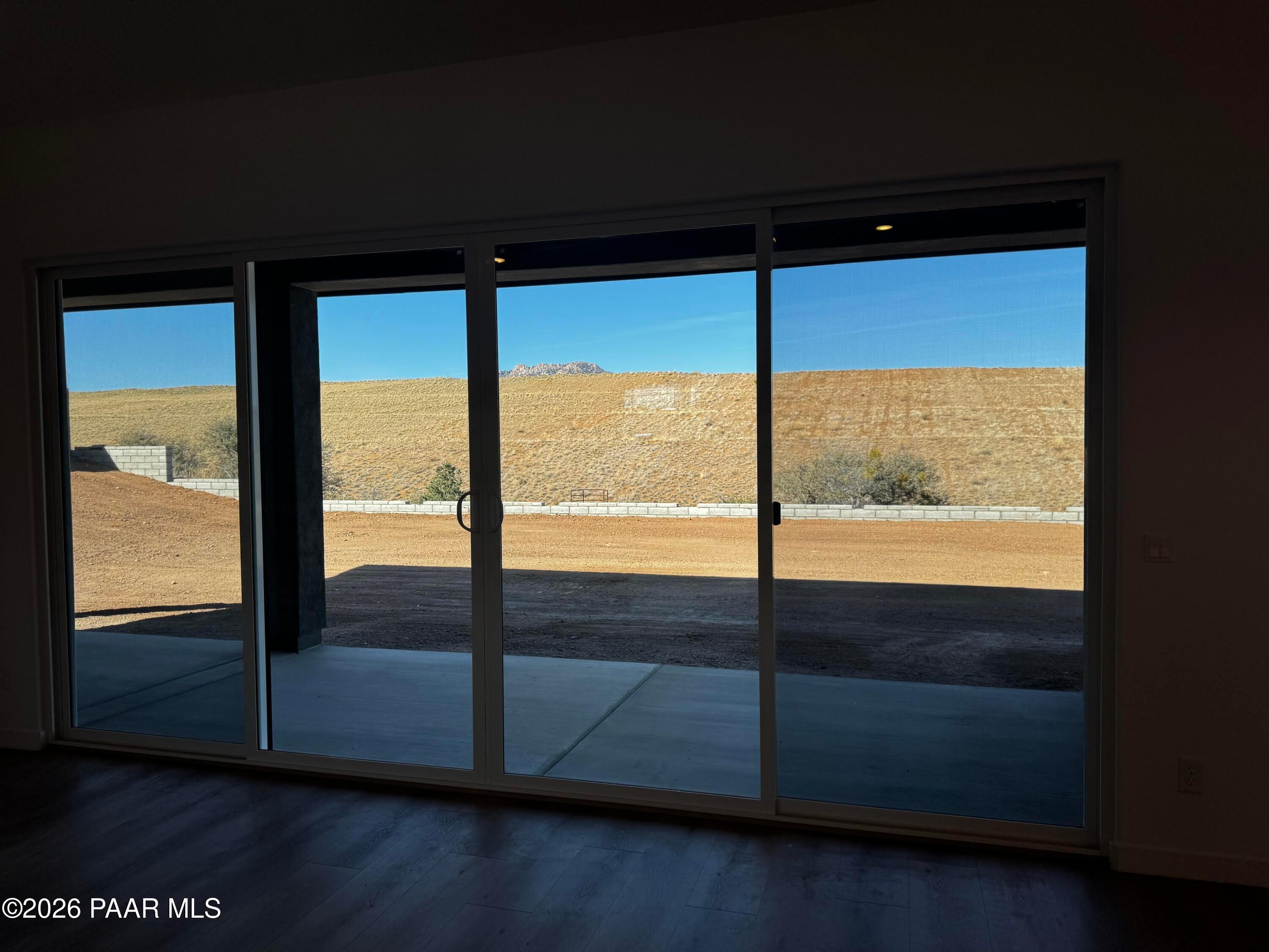 Expansive desert mountain view through triple sliding glass doors in Davidson Homes The Blaze C, Hidden Hills, Prescott, Arizona