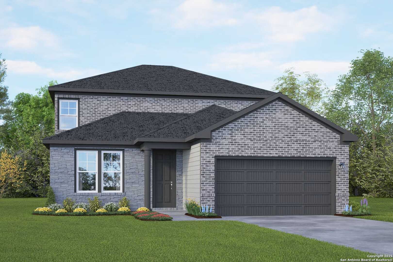 Modern two-story gray brick home with dark roof, 2-car garage, and lush front yard in Hickory Ridge, Elmendorf, Texas