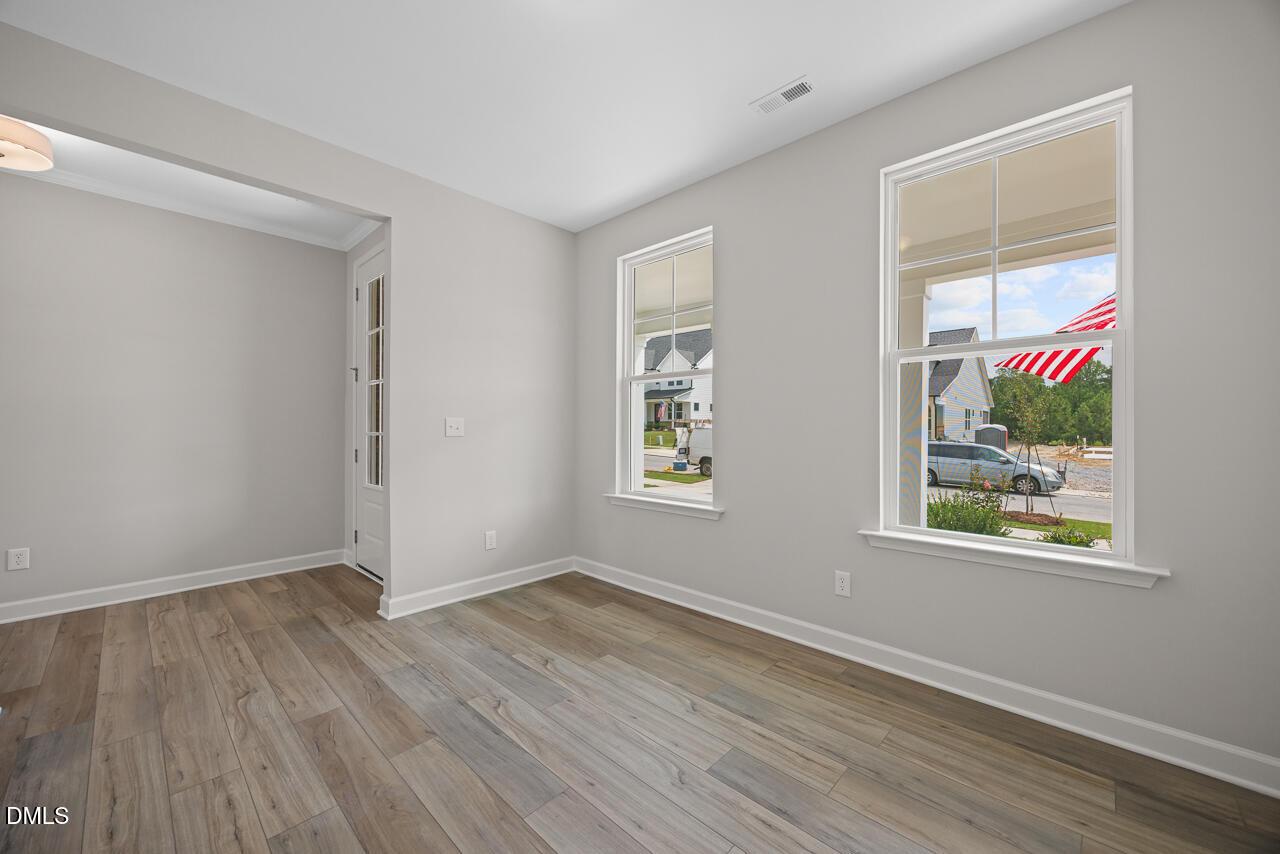 Bright, modern home office or flex room with wood-look floors in The Chestnut floor plan at Wendell Ridge, North Carolina.