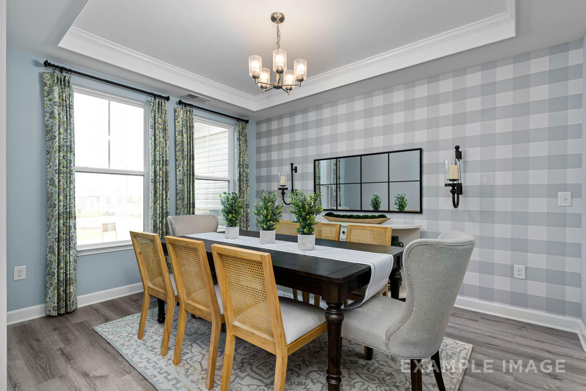 Elegant dining room in Prince Place, Fuquay-Varina NC with wooden table, rattan chairs, chandelier, and checkered wallpaper