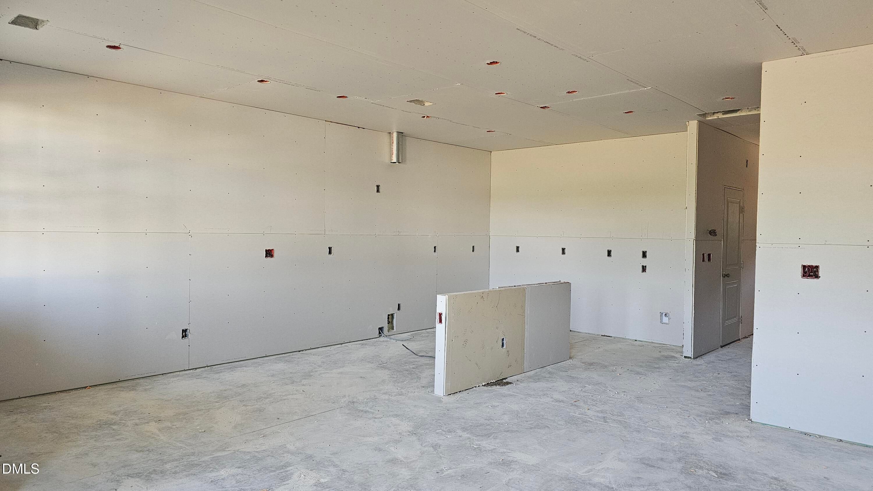 Unfinished kitchen area with drywall in The Graham Interior floor plan at Springvale, Fuquay-Varina, North Carolina.