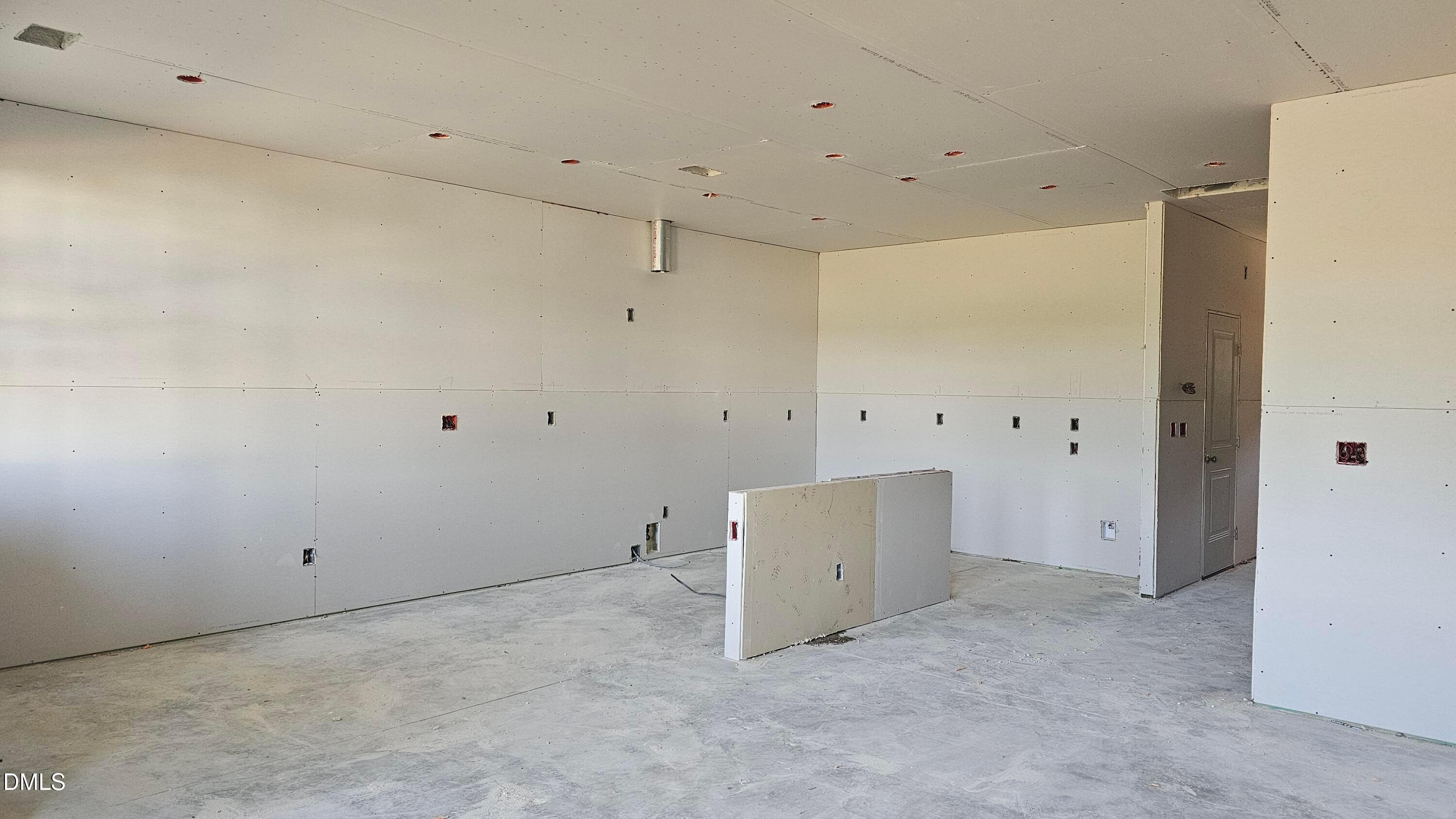 Unfinished kitchen area with drywall in The Graham Interior floor plan at Springvale, Fuquay-Varina, North Carolina.