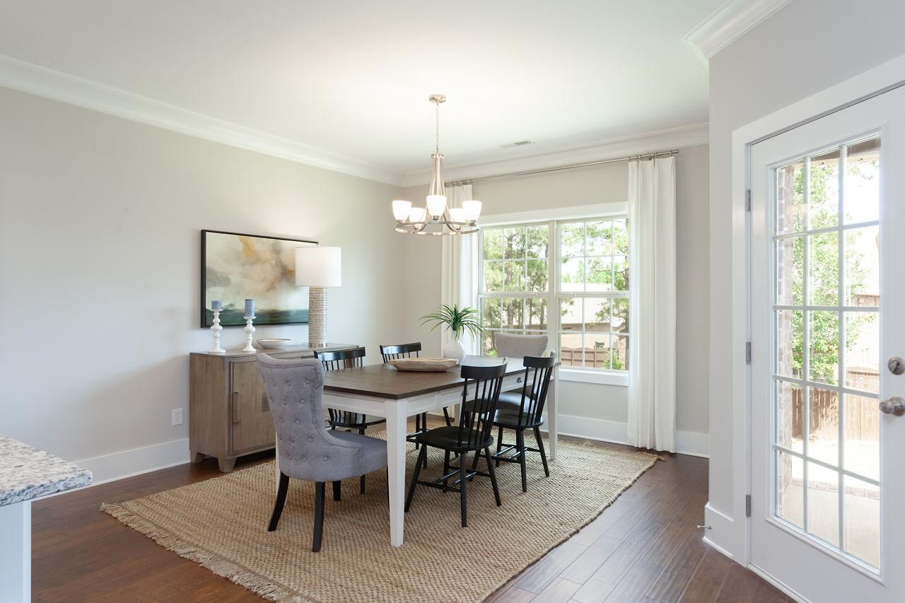 Elegant dining room at Laurenwood Preserve in Madison, Alabama with chandelier, hardwood floors, and French doors