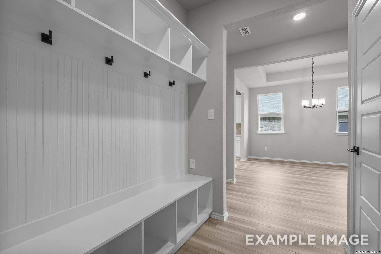 Built-in mudroom bench with storage and hooks in The Glenwood E floor plan by Davidson Homes in Royal Crest, San Antonio.