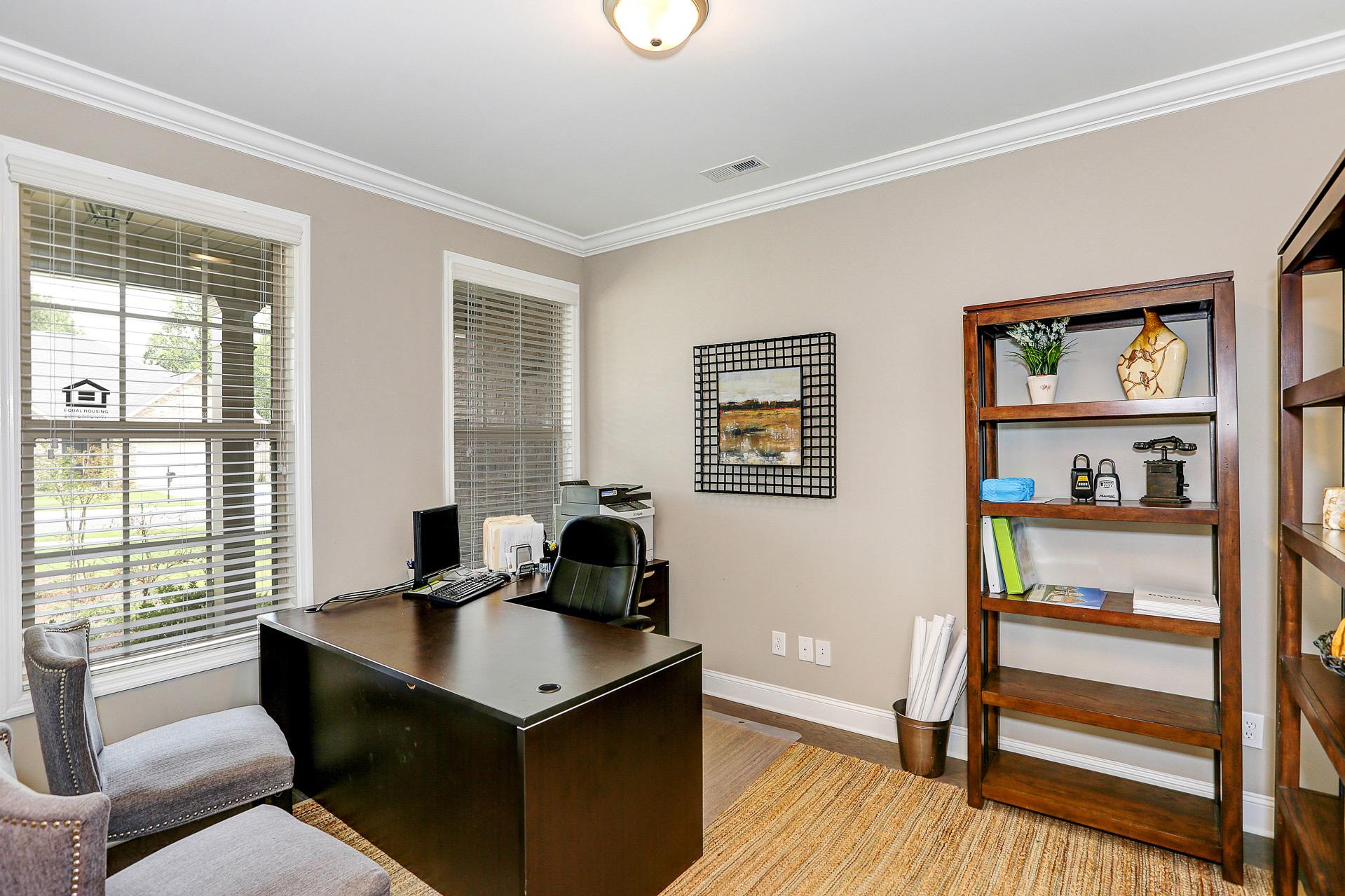 Cozy home office in Stone Creek Phase II Cullman AL with wooden desk, bookshelves, beige walls and window blinds