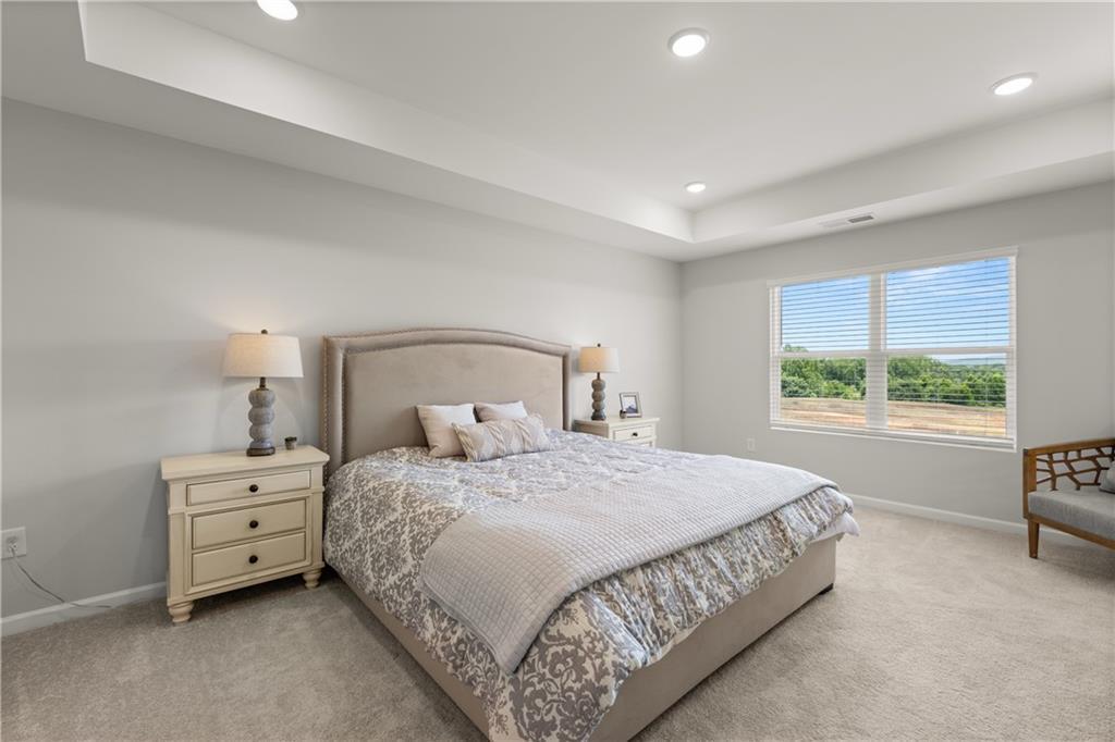 Spacious primary bedroom with tray ceiling in The Wake B floor plan by Davidson Homes in Hemingway, Cumming, Georgia.