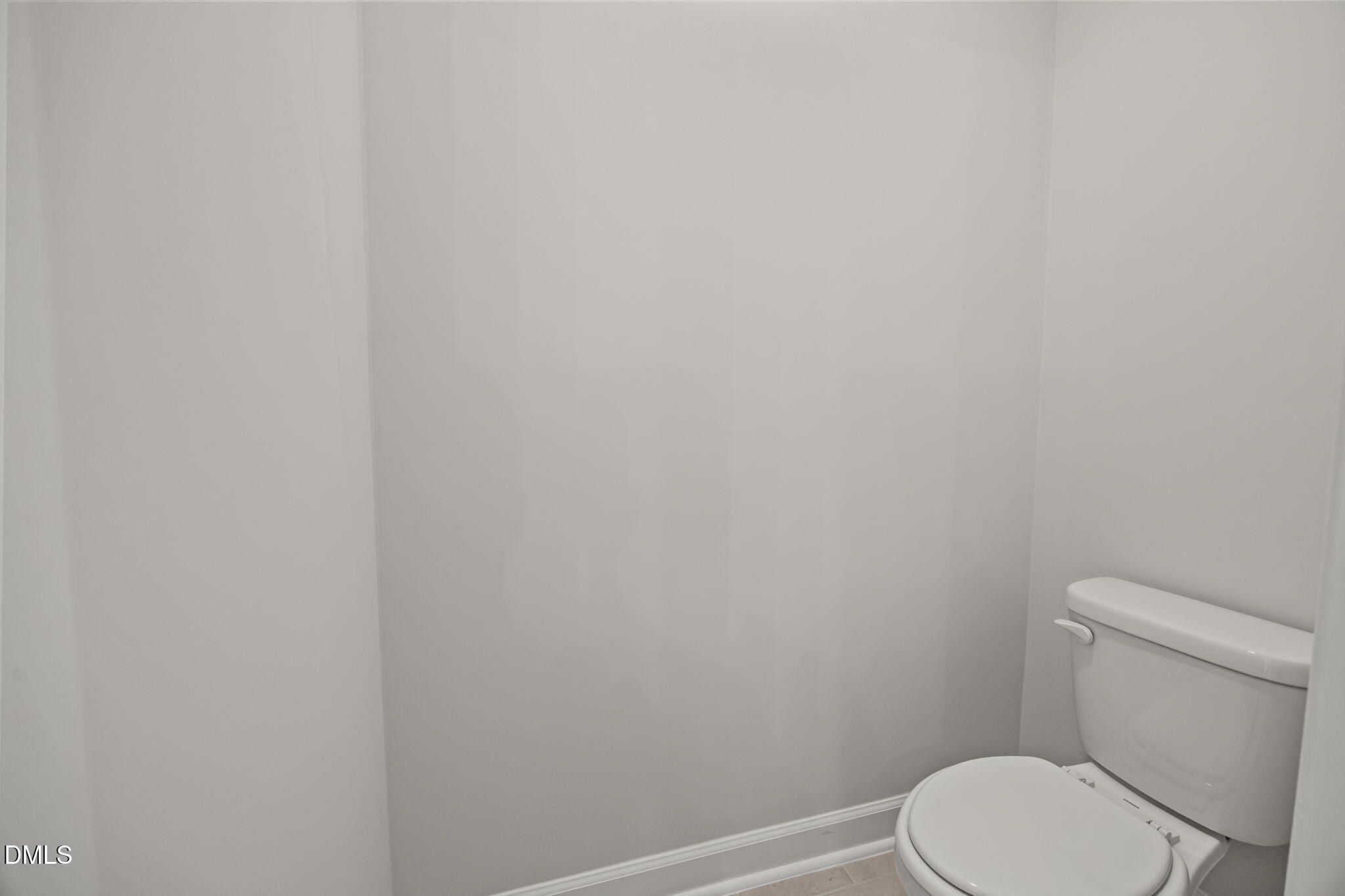Modern white toilet in spacious powder room of 4-bedroom Davidson Homes Willow D, Wendell, NC