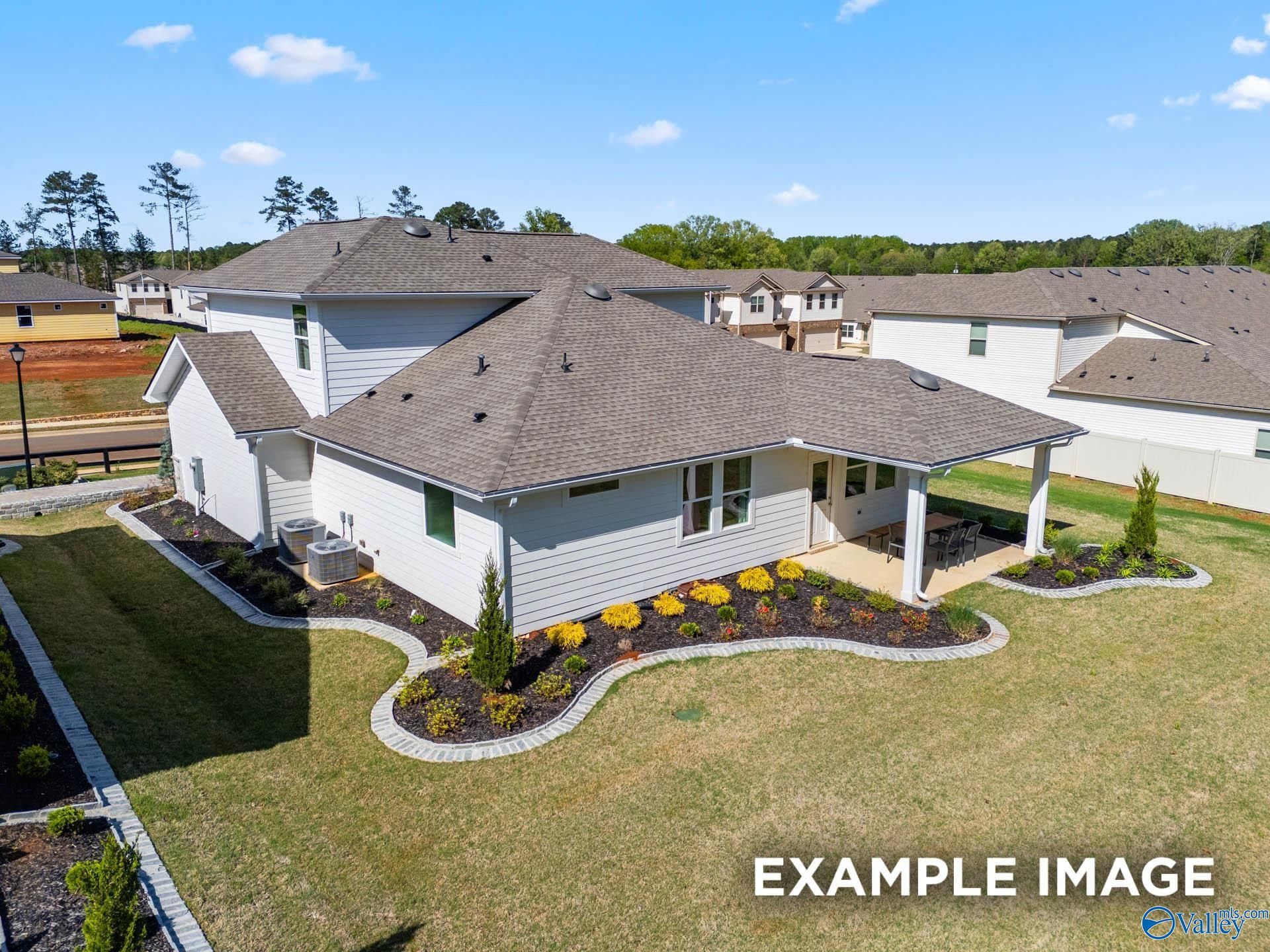 Aerial view of two-story The Stella home by Davidson Homes in Evergreen Mill, Madison, Alabama, featuring attached garage and landscaped yard