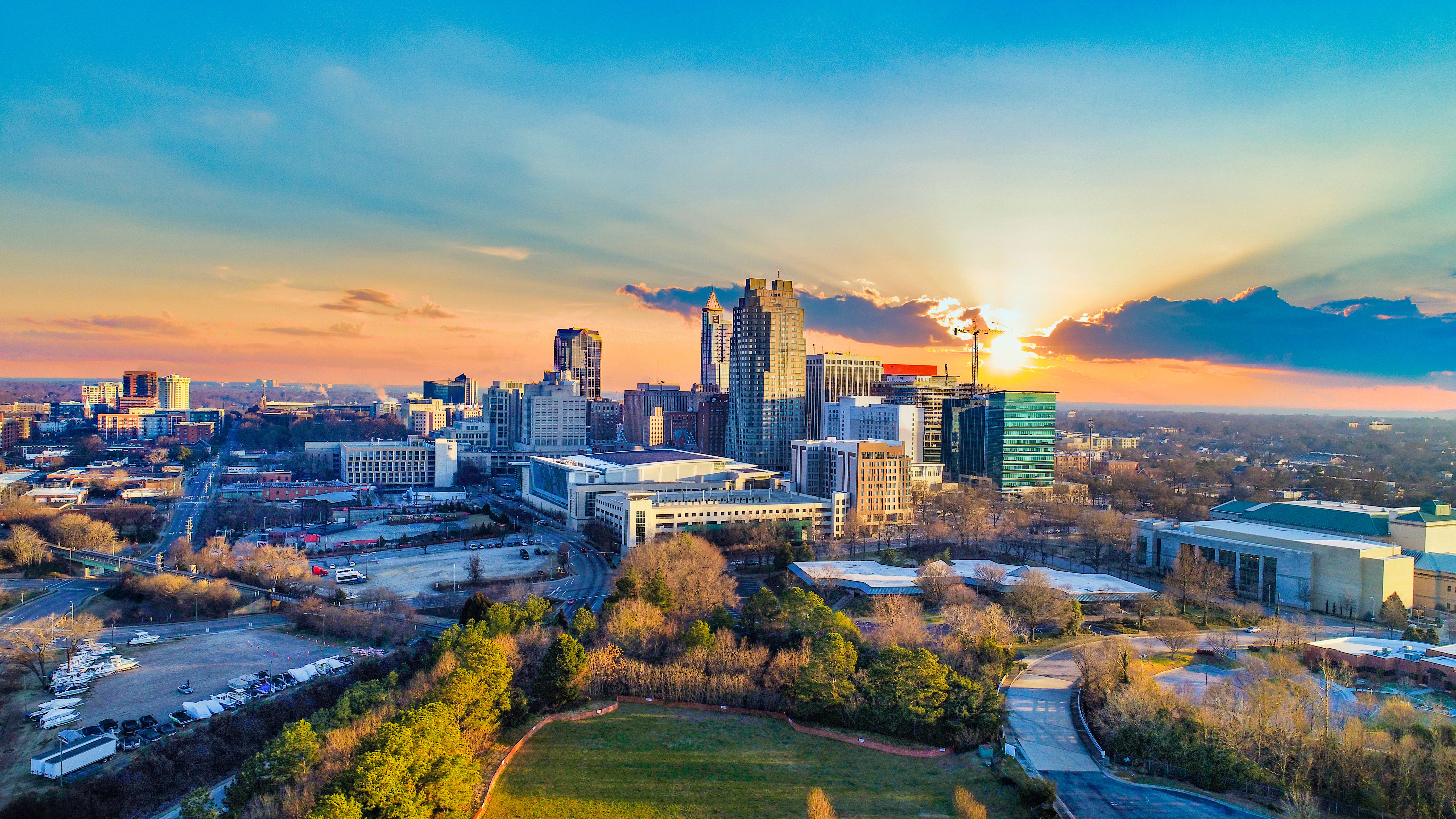 Aerial view of Raleigh skyline at sunset near Forestville Yard in Knightdale NC with modern high-rises and green parks