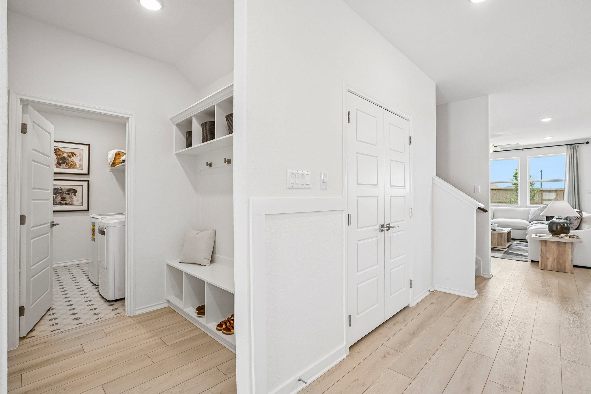Mudroom with built-in bench and laundry room at Morgan Meadows in San Antonio by Davidson Homes.