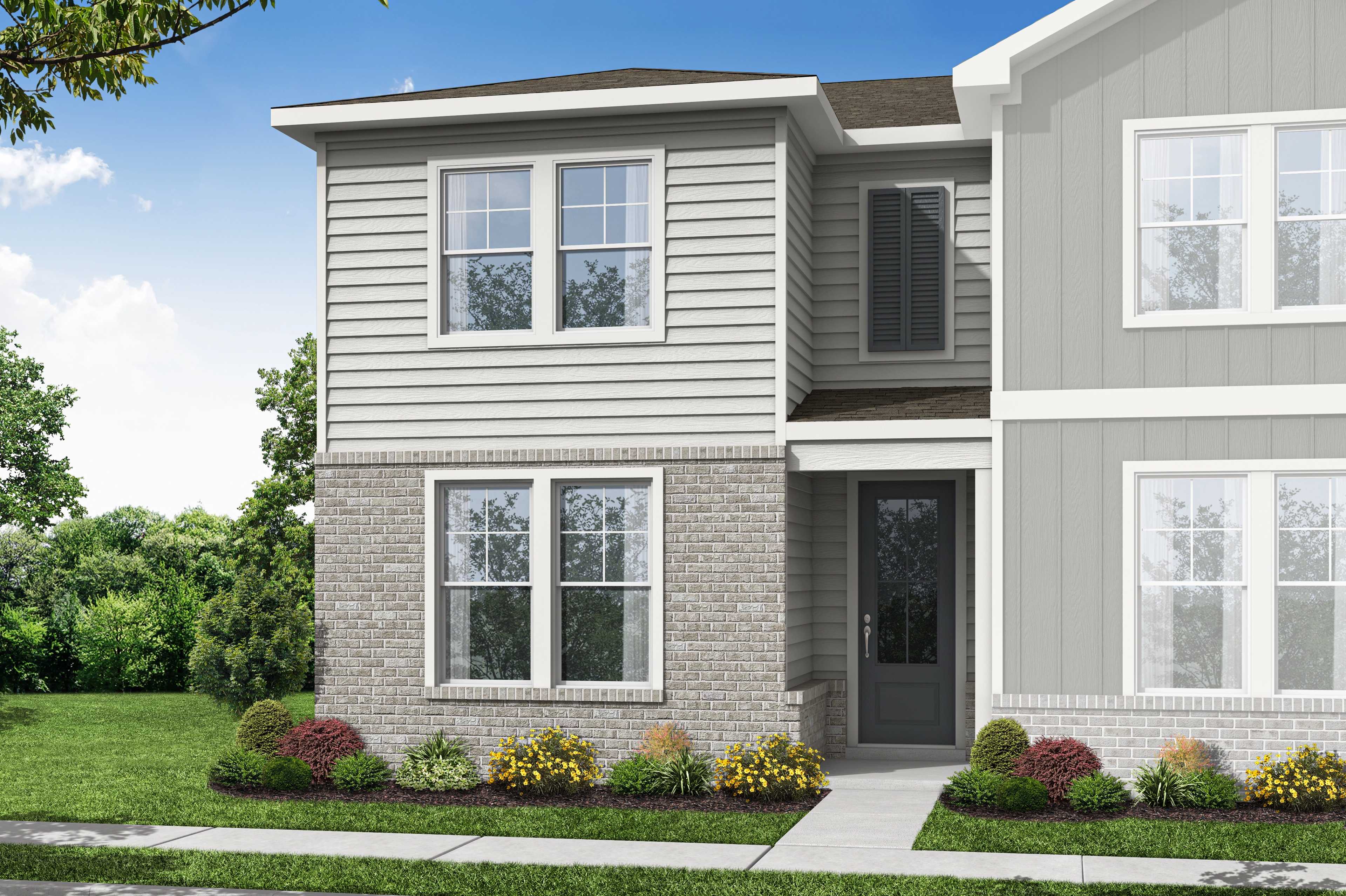 Two-story Monroe A elevation with gray siding, brick accents, large windows, covered entry, and lush landscaped yard by Davidson Homes