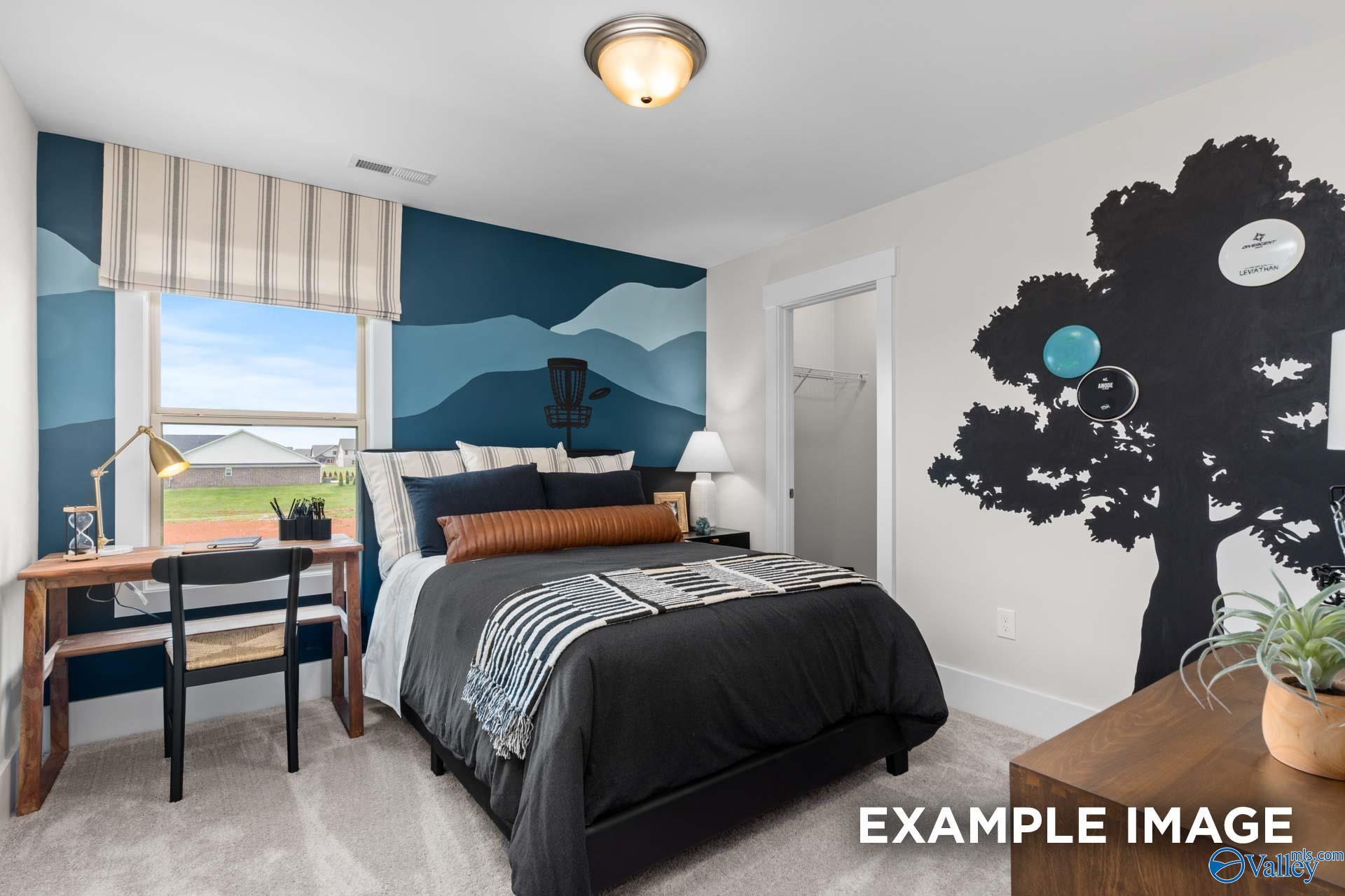 Stylish bedroom with mountain-themed accent wall, desk nook, and tree mural in Davidson Homes The Chelsea A, Ivy Hills, Toney, Alabama