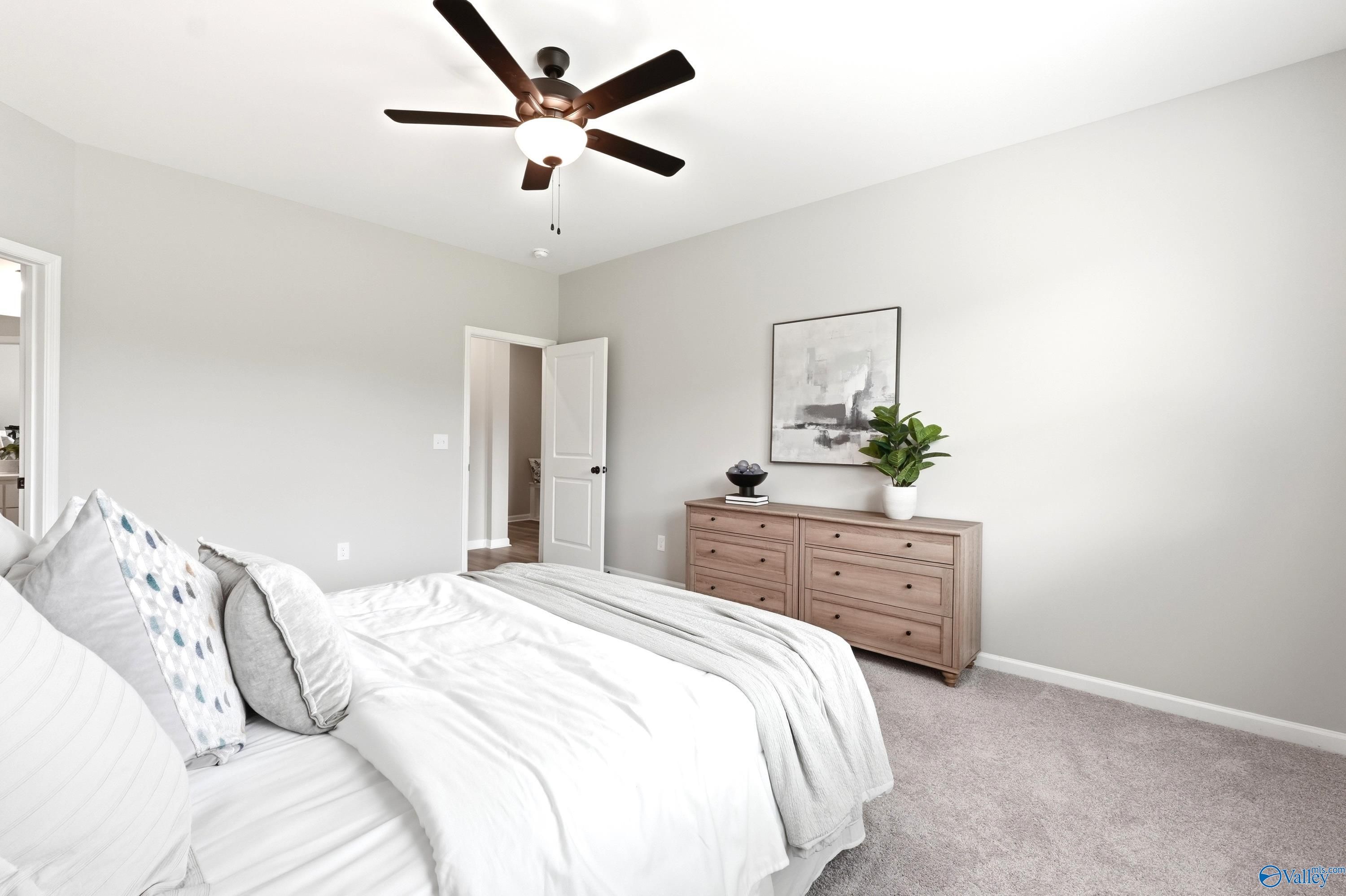 Bright bedroom with neutral decor and ceiling fan in The Dorado floor plan at Riverton Preserve, Huntsville, Alabama.